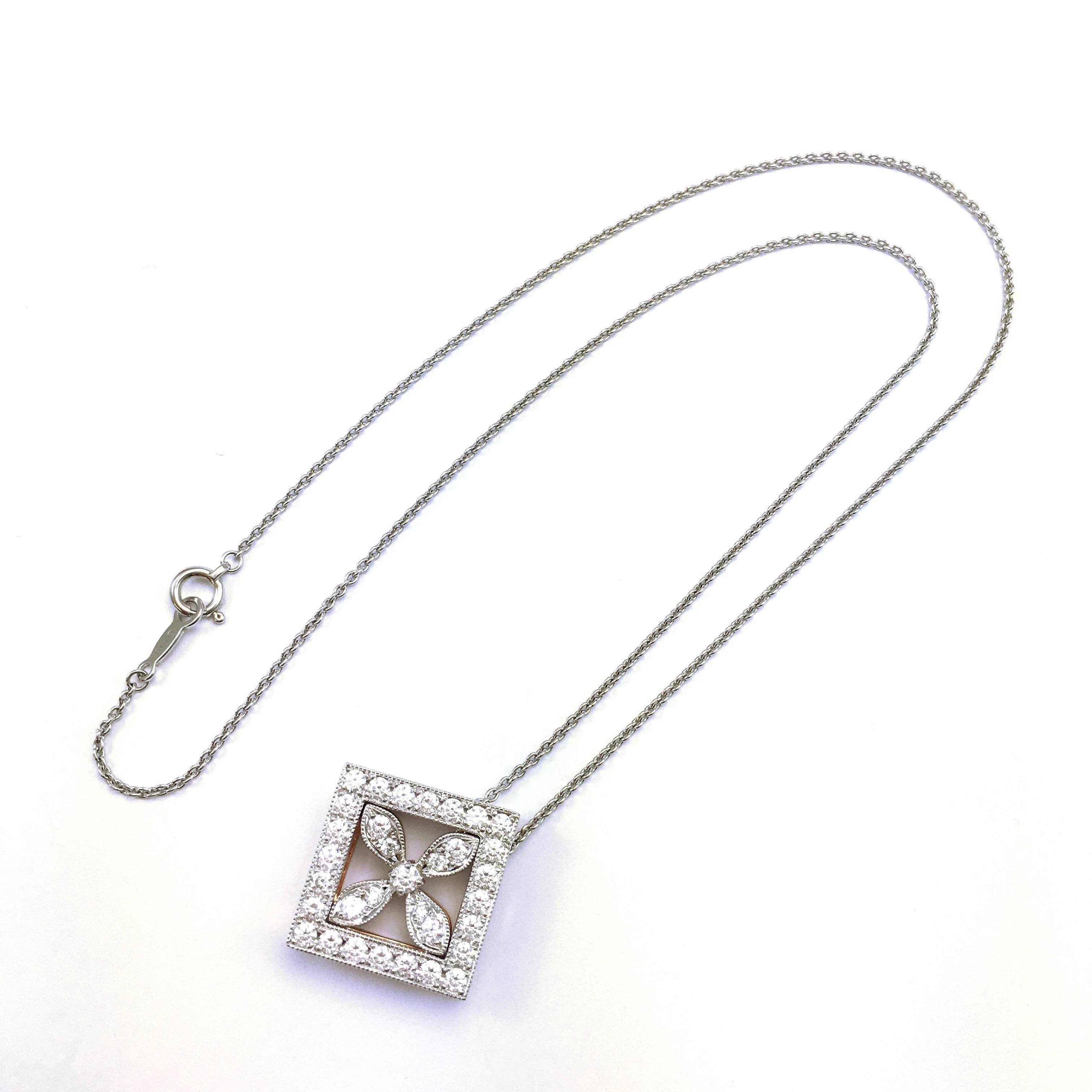 Gorgeous piece of jewelry from Mikimoto. Unusual, because Mikimoto is known for their pearls, but they also created some high quality diamond jewelry. 18K white and rose gold pendant on 16" white gold chain. The pendant is composed of two