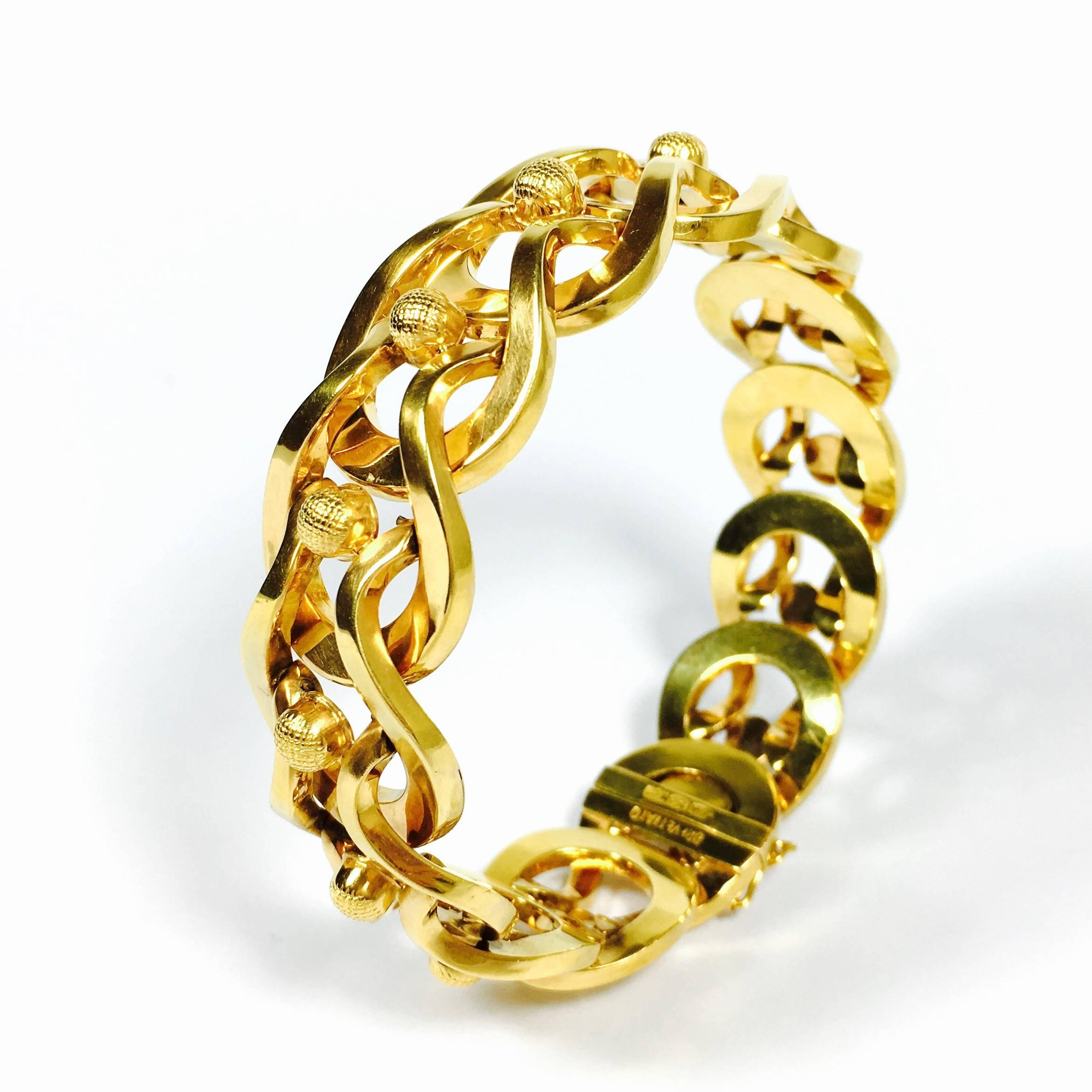 Very unique and gorgeous 18K yellow gold bracelet from the italian jewelry company Brevettato. Flexible when opened, but acting like a bangle closed on the wrist. Excellent workmanship. 20 mm wide. 
Weight: 35.4 grams
Fits up to a 7 inch wrist. 