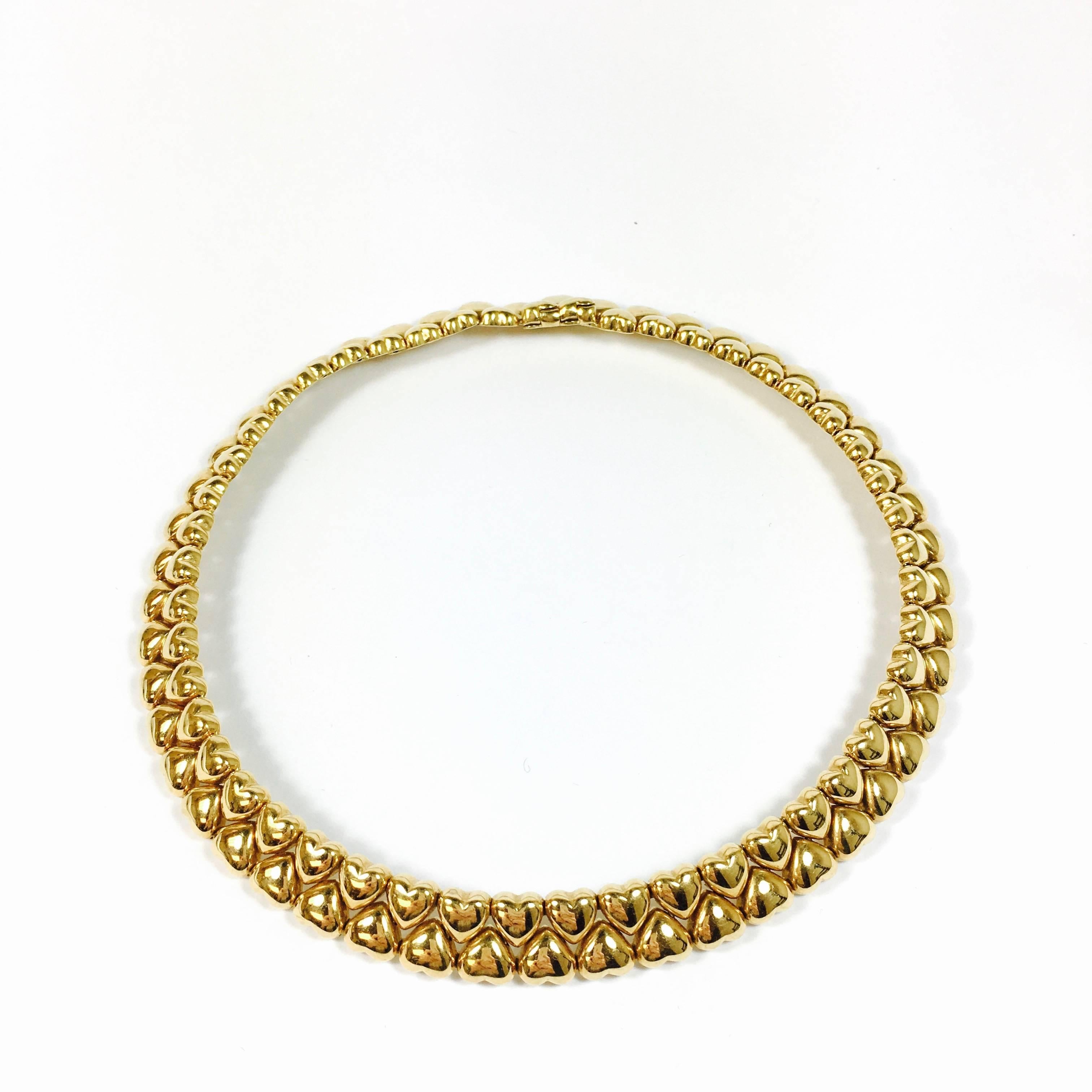 Vintage Cartier collar necklace in 18k yellow gold from the Double Coeurs 1994 collection, features two rows of heart-shaped links. Original box and cerificate of authencity included. 
Measurements:
Length: 15 inches
Width: 0.5 inch
Weight: 88.2
