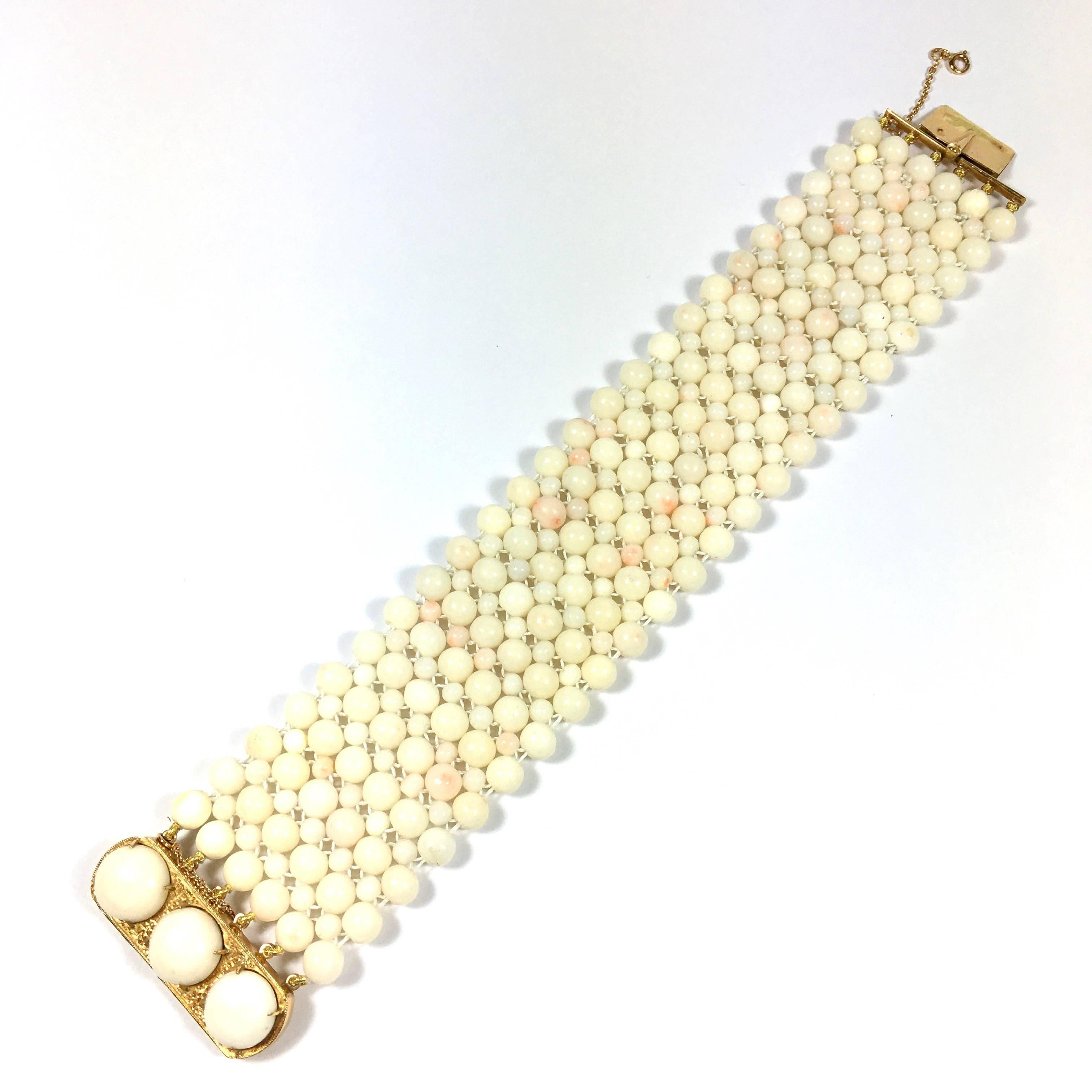 Gorgeous coral bracelet, composed of 6 rows of 6 mm coral beads with 3.5 mm beads in between. 18k yellow gold clasp set with three 11 mm corals and stamped with the french import hallmark (owl) and 75 for the Paris assay office. 