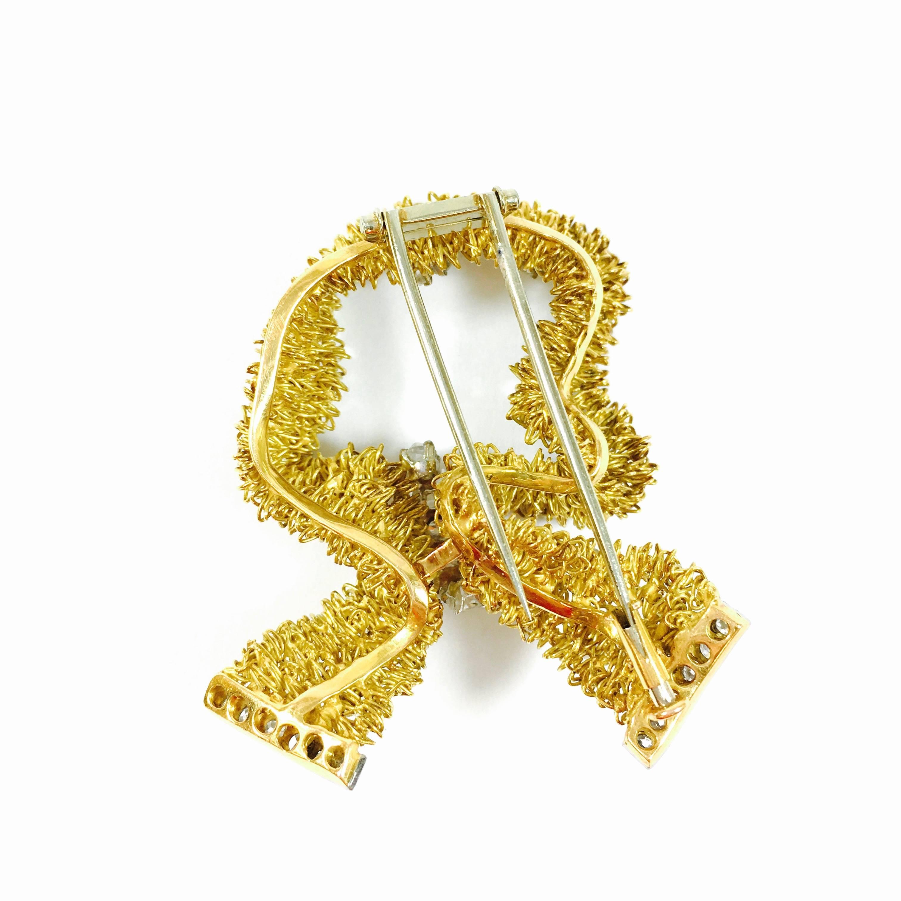 18K yellow gold and platinum ribbon, set with old mine, old european and single cut round and cushion diamonds.
Approximate total diamond weight: 3.00ct  Color: G-H, Clarity: VS1-VS2
Measurements: 
Length: 2 inches
Width: 1.75 inches
Weight: