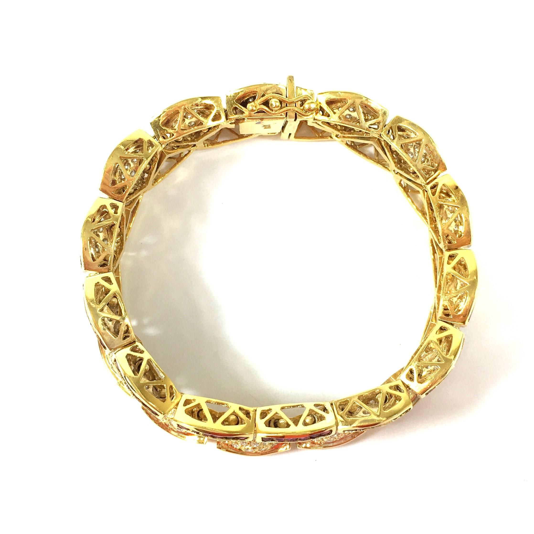18K yellow gold flexible bracelet, featuring a design two rows of cascading scalloped gold links.
Approximate total diamond weight: 8.00ct  Clarity: VS1-VS2, Color: G-H
Approximate total ruby weight: 5.5ct
Measurements:
Length: 7.25