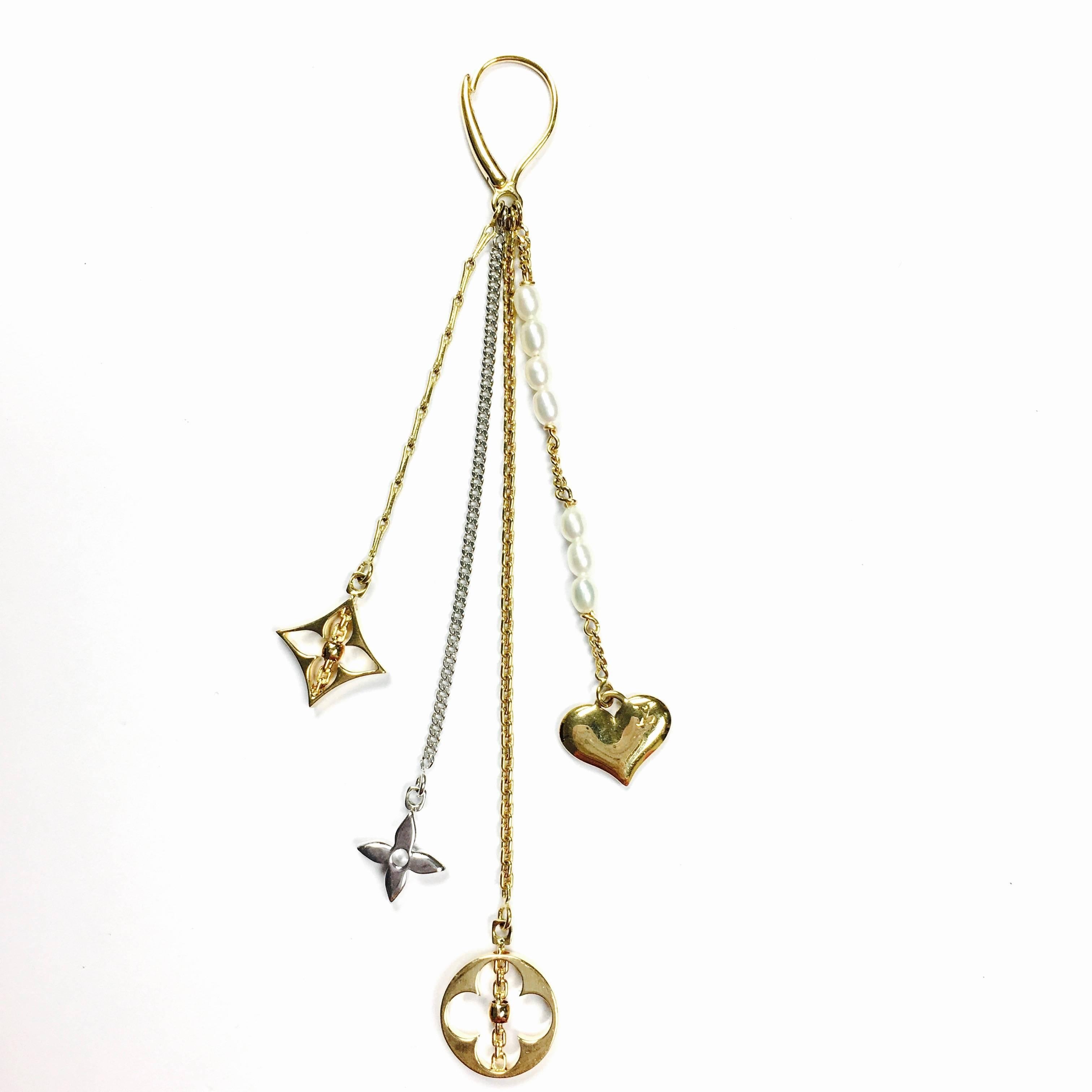 Louis Vuitton Monogram multi-strand 18K yellow and white gold dangle earrings. Each earring features five various length of chains with cultured pearls, heart charm and monogram charms. 18K yellow gold lever back closures. 
Metal Type: 18K Yellow