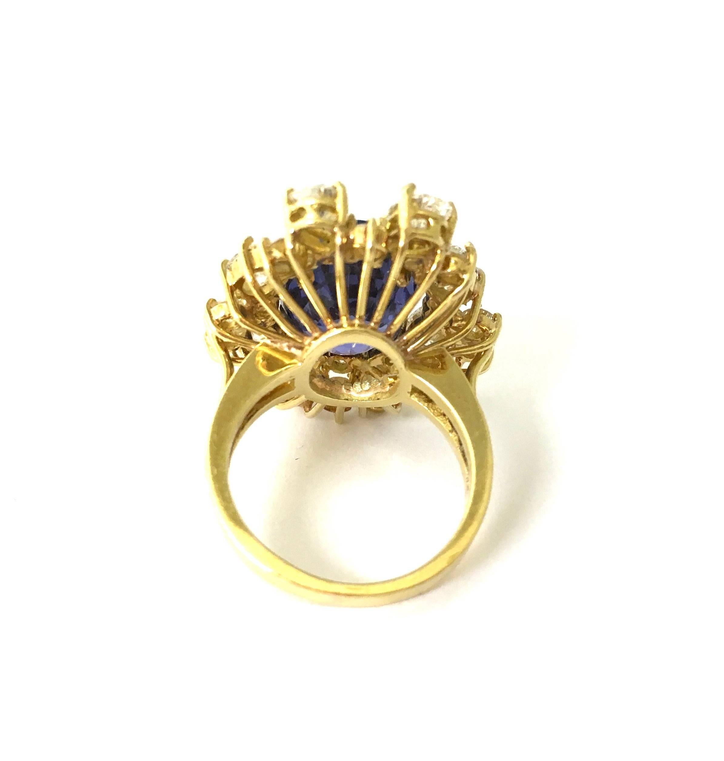 Crafted in 18K yellow gold, featuring an oval cut blue sapphire set within a bezel of pear shape, oval and round brilliant cut diamonds, supported by 2.5 mm wide band. 
Sapphire: 12.67 x 10.7 x 7.18 mm Ceylon no heat sapphire, AGL Report#