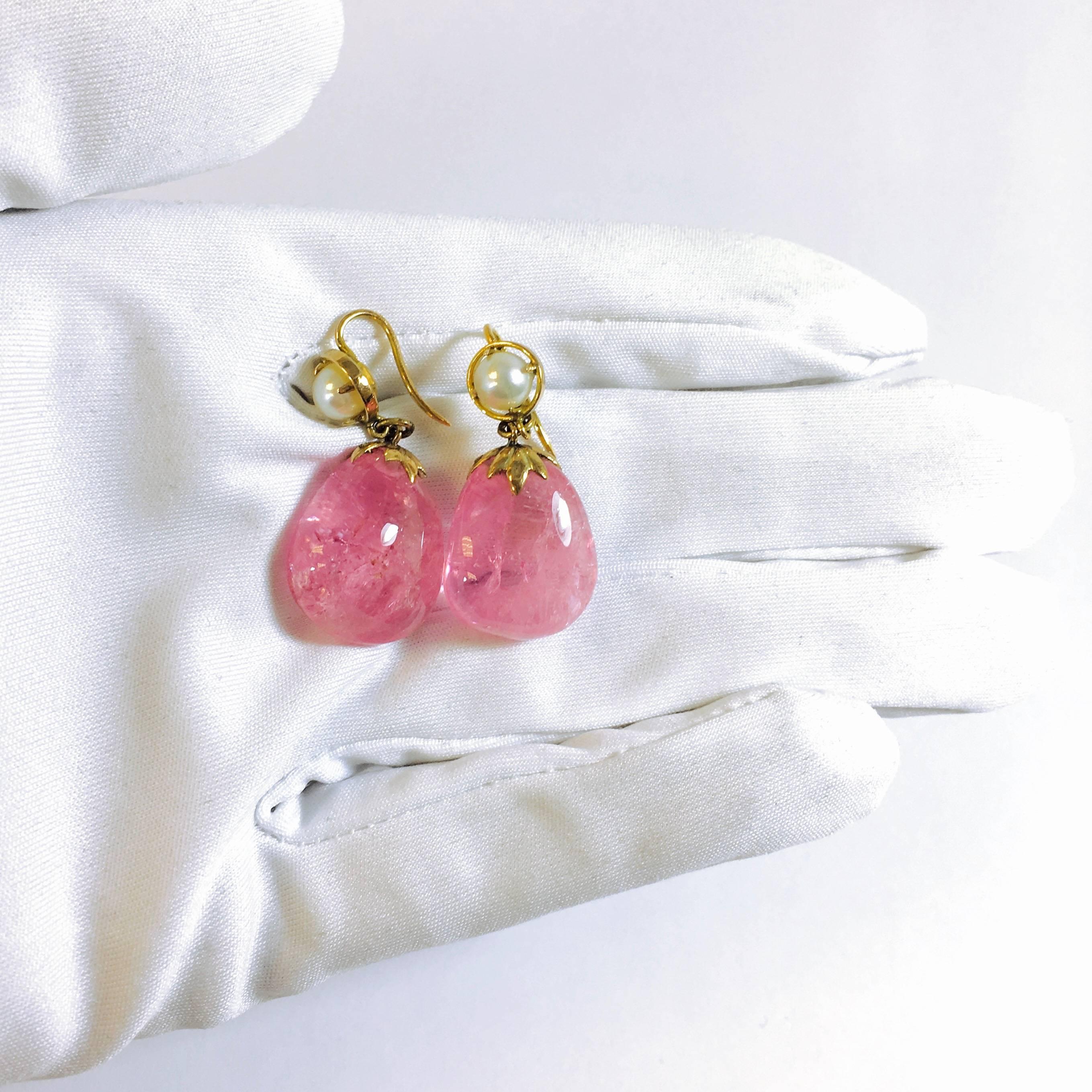 Gorgeous bubble gum pink free form chinese pink tourmaline earrings. Each earring is composed of an approximately 18 x 15 x 10mm unfaceted, polished pink tourmaline supported by a 14K yellow gold foliate cap, a 5.5 mm cultured pearl and a shepard