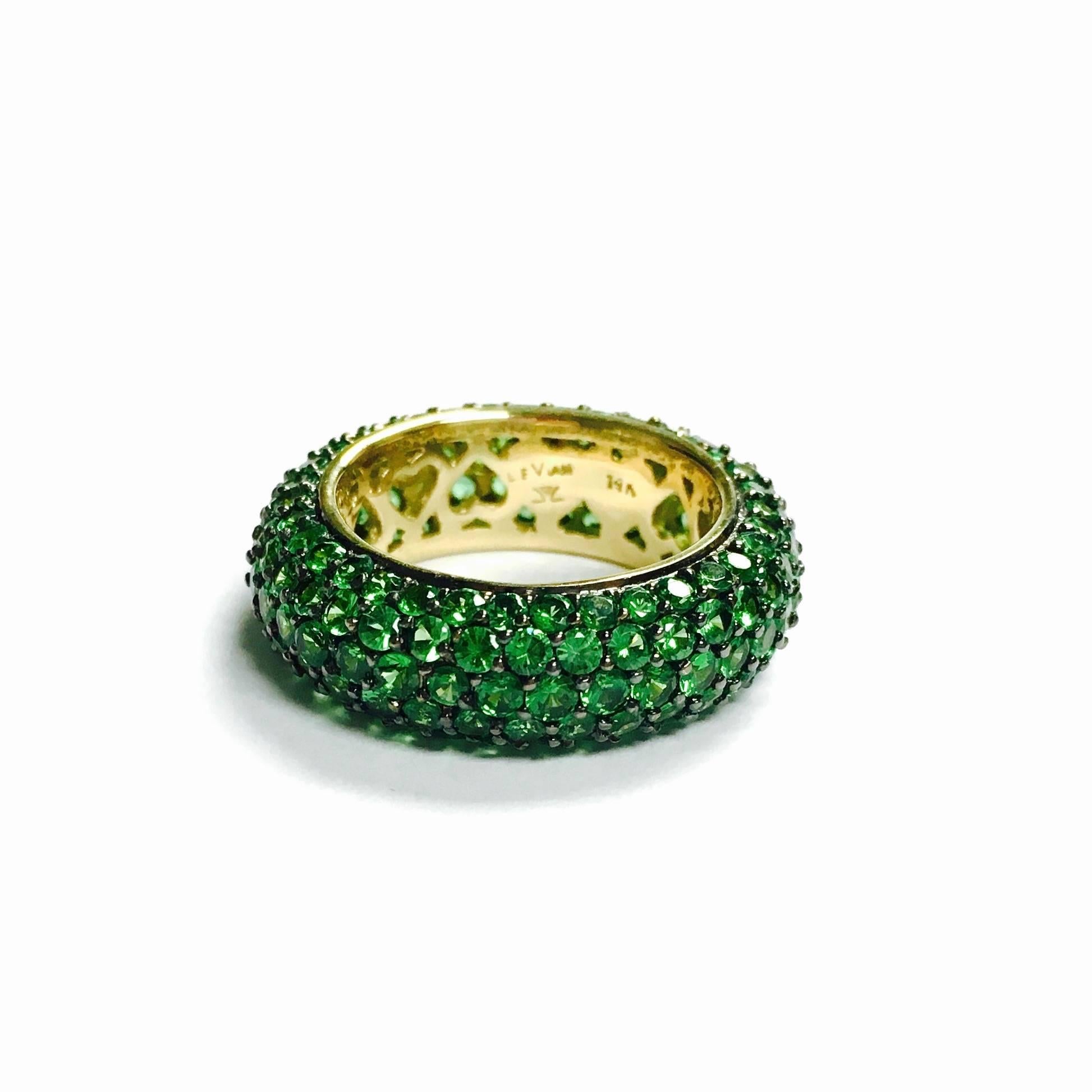 Gorgeous 14K yellow gold domed eternity band set with approximately 2.70ct of round cut, vivid green tsavorite garnets. 
Size: 6.5
Weight: 7.3 grams
