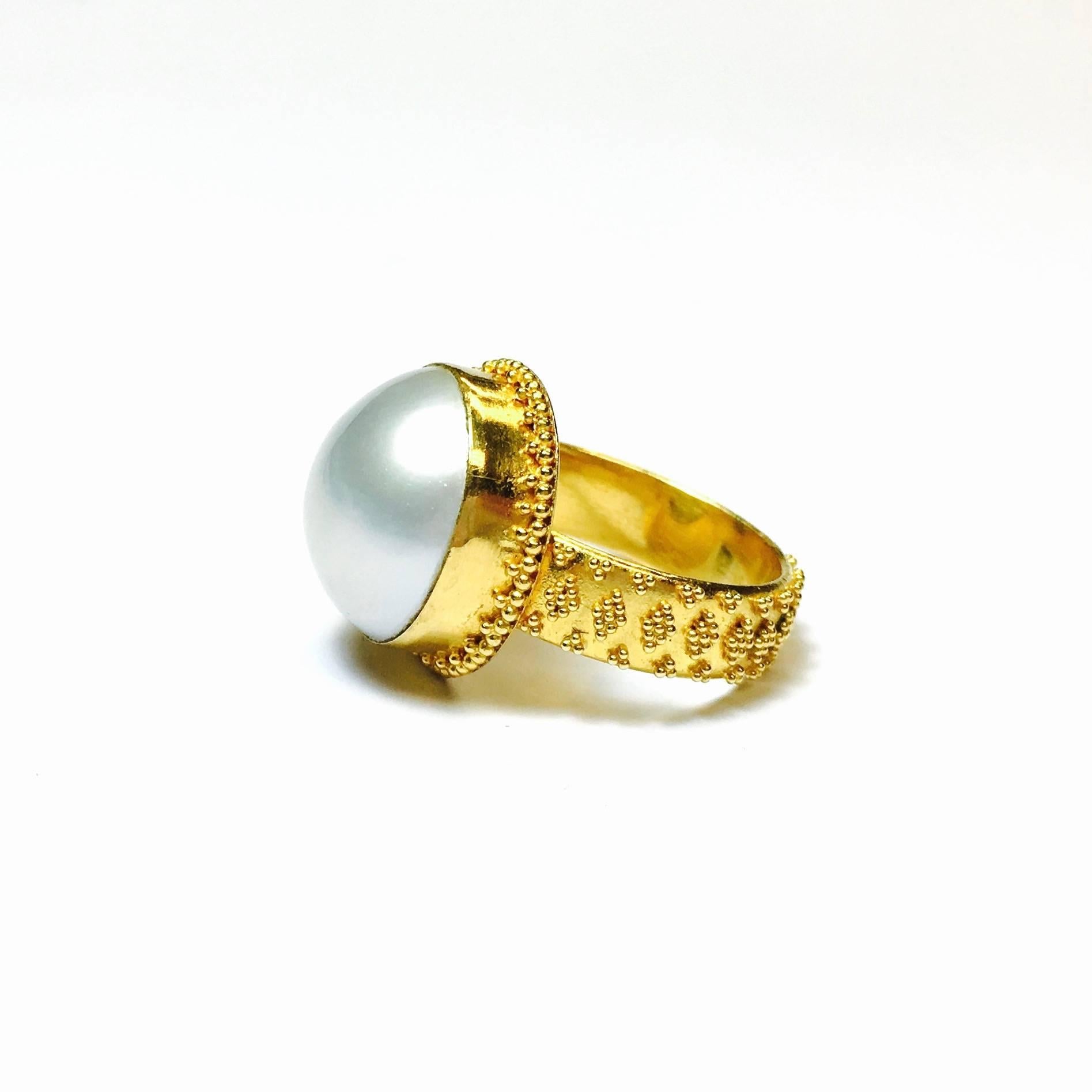 22K gold hand crafted beaded ring, featuring a 15mm round, white mabe pearl.
Size: 6.75
Weight: 8.7 grams