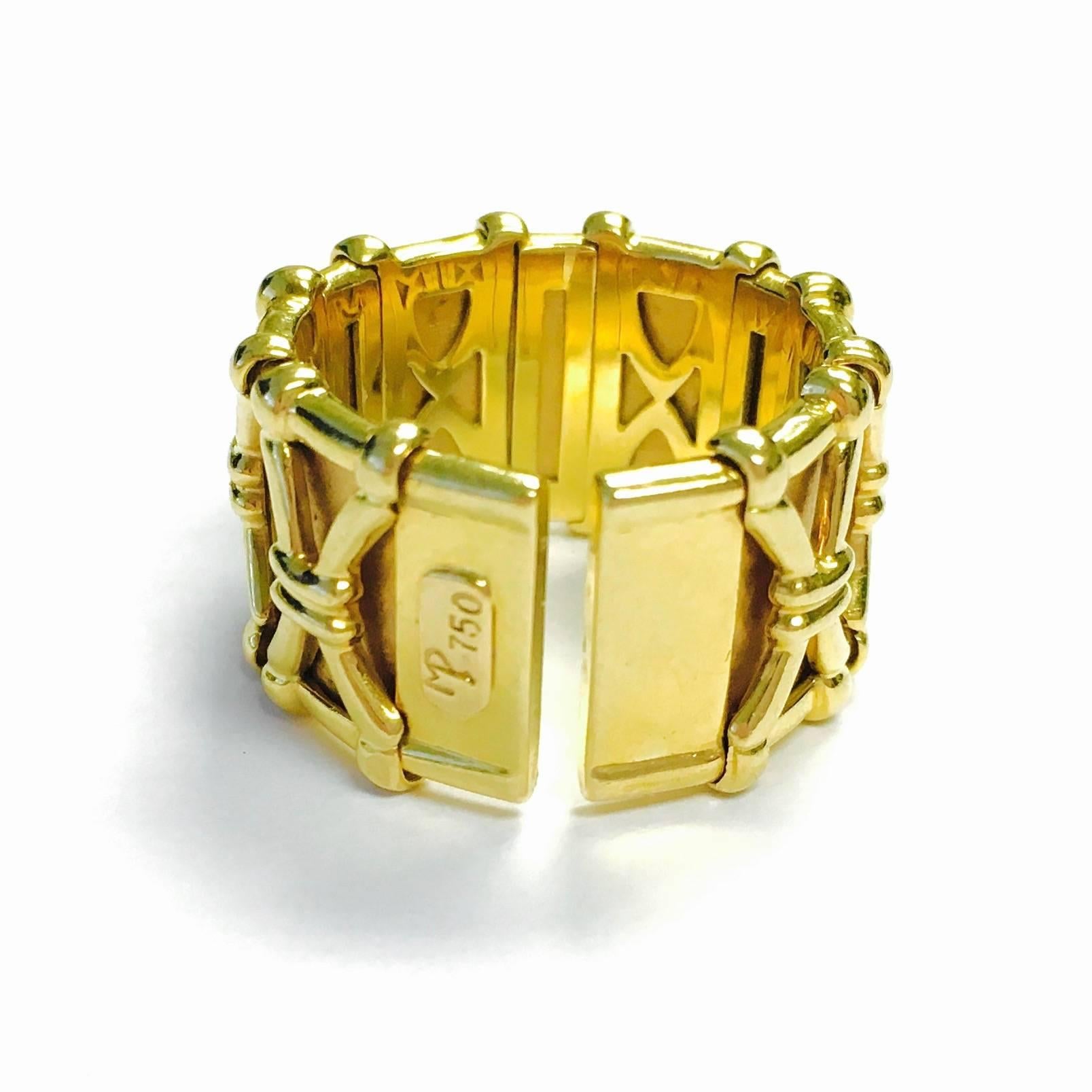 18K yellow gold 0.5 inch wide, open cuff style ring with twelve round brilliant cut diamonds, set in bezels. The ring is a size 6.5, but it does flex enough to allow to comfortably slip onsize 7 finger. This flexible design works great for us with
