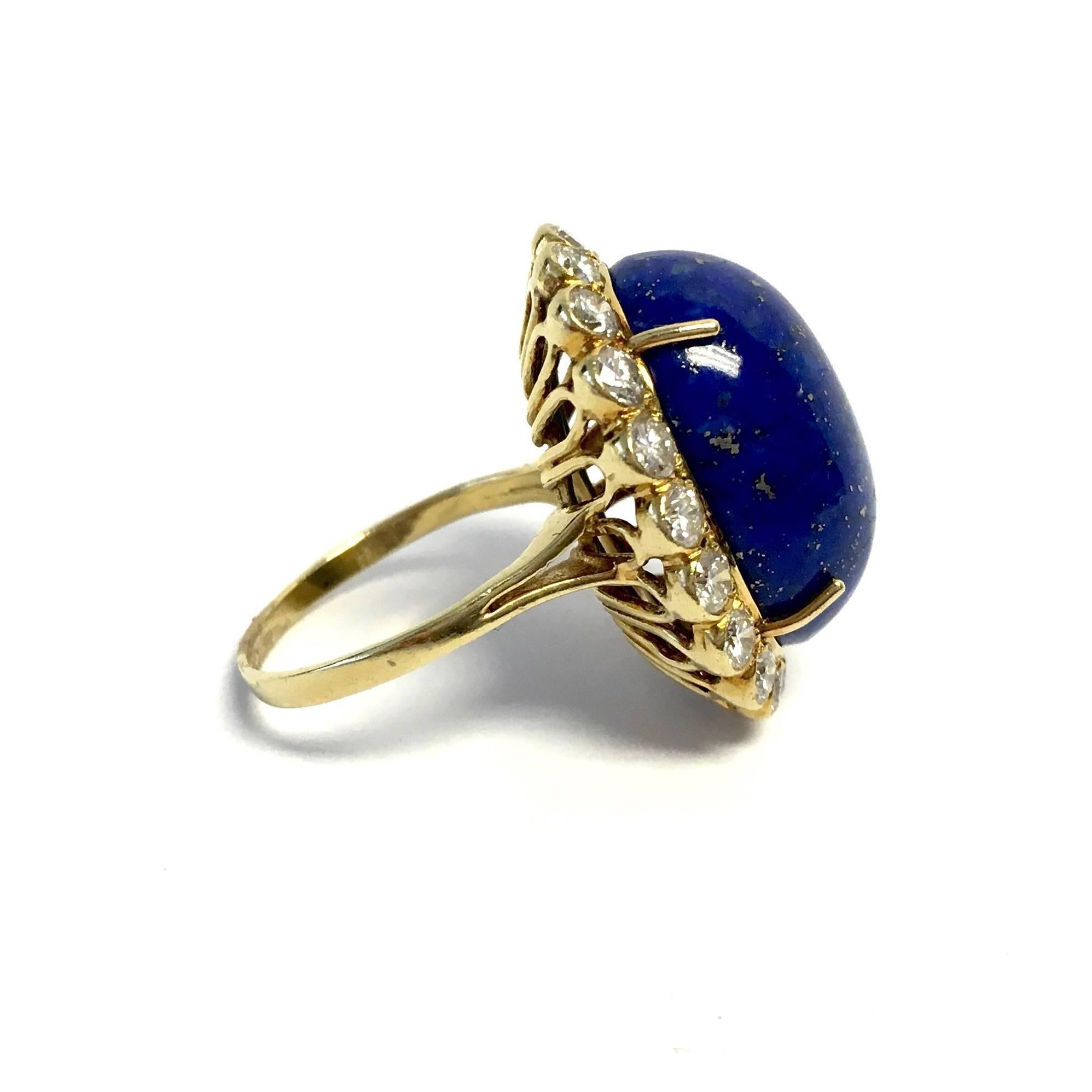 This timeless design features beautiful 17.20ct oval cabochon lapis lazuli, surrounded by diamonds, supported by a split shoulders and a two millimeter wide band. 
Diamond weight: 2.00ctw Color: F-G, Clarity: VS1-VS2
Weight of the ring: 10