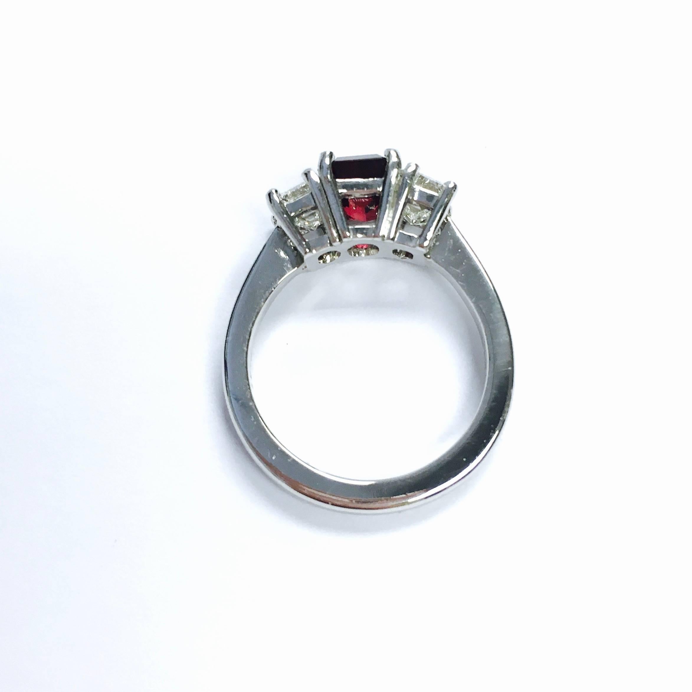 Crafted in platinum, featuring a deep red emerald cut natural ruby solitaire flanked by emerald cut diamonds on each side. 
Ruby: 1.83ct GIA No Heat, Report# 1166213667
2 Diamonds: 1.50ct total weight, Color: H-I, Clarity: VS1-VS2
Weight: 8.2