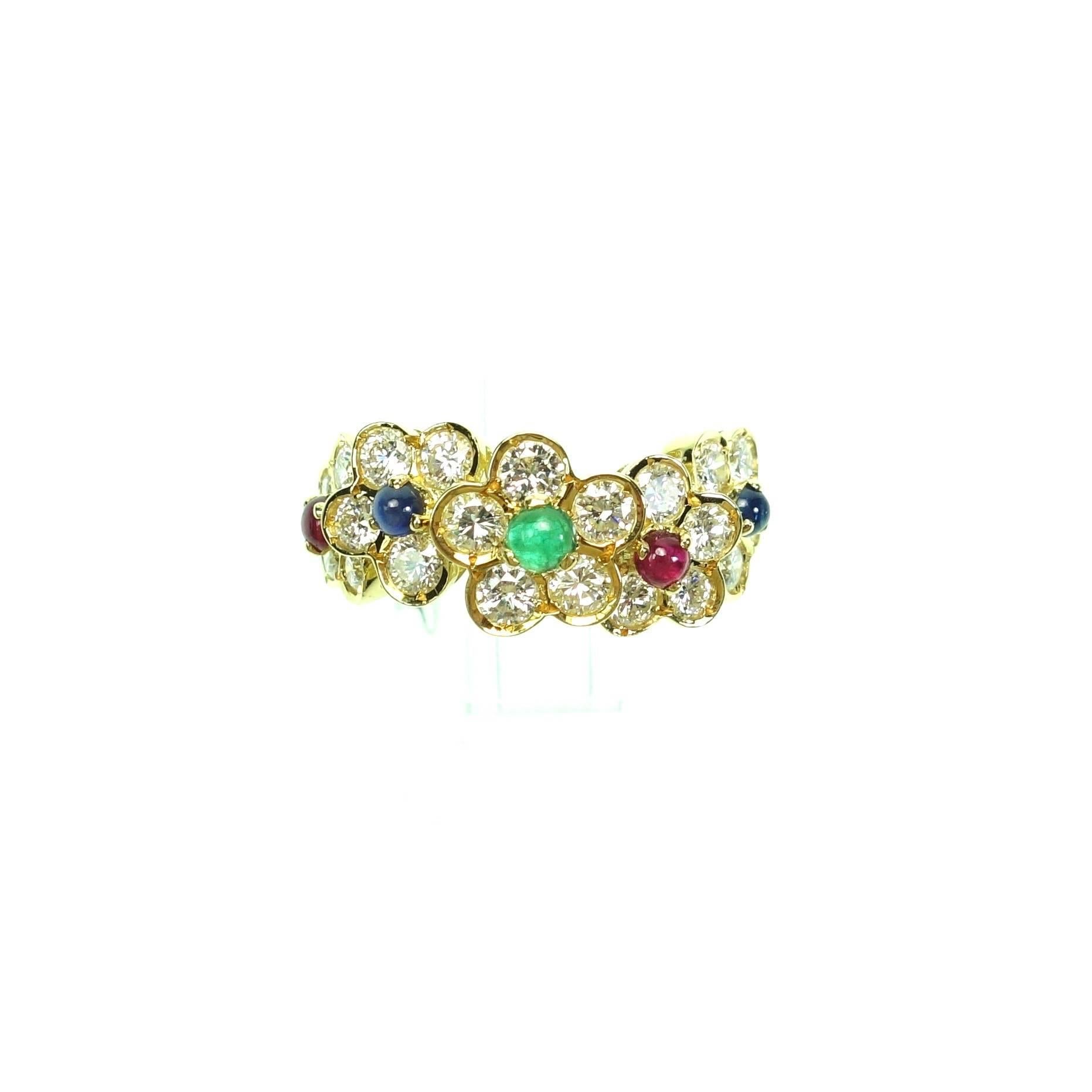 Rare Vintage Van Cleef & Arpels 18K Yellow Gold Emerald, Sapphire, Ruby Cabochon & Diamond five Fleurettes Ring. The 3-tiered front features 5 diamond florets with emerald, ruby and sapphire centers. Stone Details: 21 brilliant round cut diamonds,