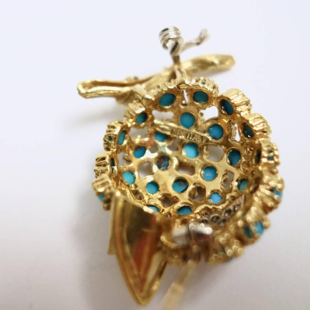 Just a sweet, colorful bird brooch. Crafted in 18K yellow and white gold, the body is made of individually set round turquoise cabochons, the eye is set with diamonds and one round ruby. High quality stones and excellent workmanship. 
Measurements: