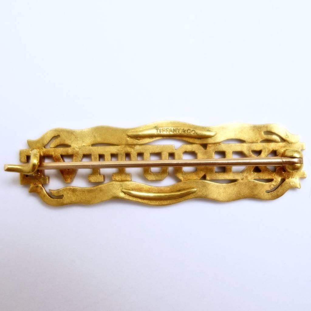 Rare 18K yellow gold Coney Island Jockey Club Executive pin made by Tiffany & Co. 
Measurements: 42 mm W x 11.5 mm H
Weight: 5.5 grams
Short history:
On June 10, 1886 the Coney Island Jockey Club opened the first turf racecourse in the United