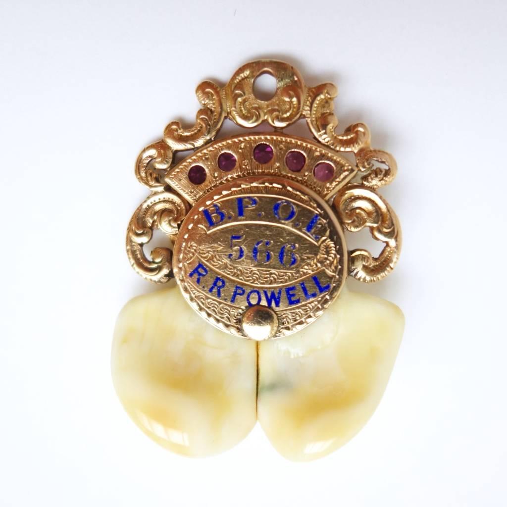 Amazing large Elks Lodge pendant crafted in 14K yellow gold, decorated with five round pink sapphires, approximate total weight of 0.50ct, two small round rubies (elk's eyes), blue enamel work and twin elk's tooth. On the back there is blue