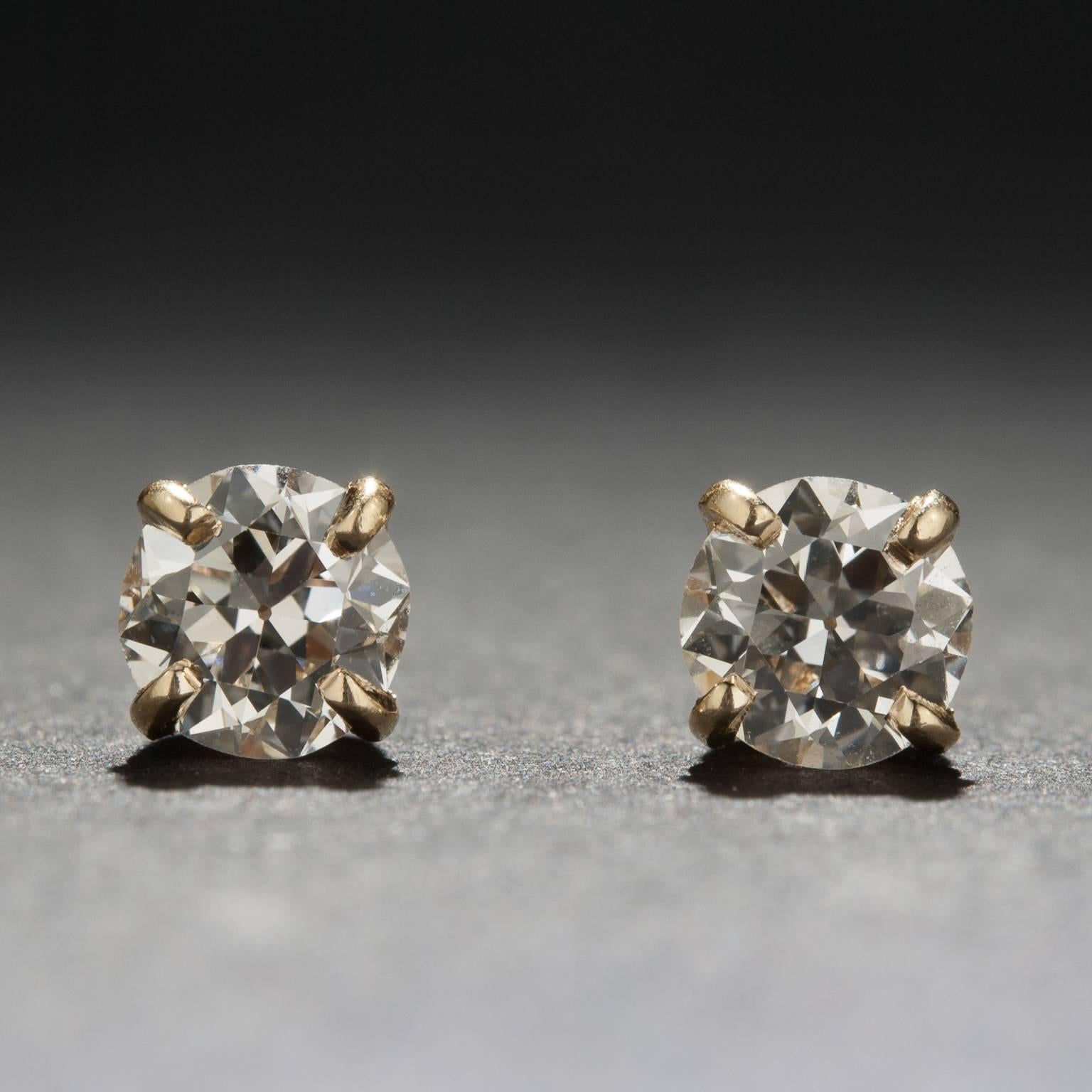 These stunning diamond studs are made of of two Old European Cut diamonds with a combined weight of 1.00 carats. Each diamond is secured by a four-prong 14k yellow gold setting with a screw-back fastener. 