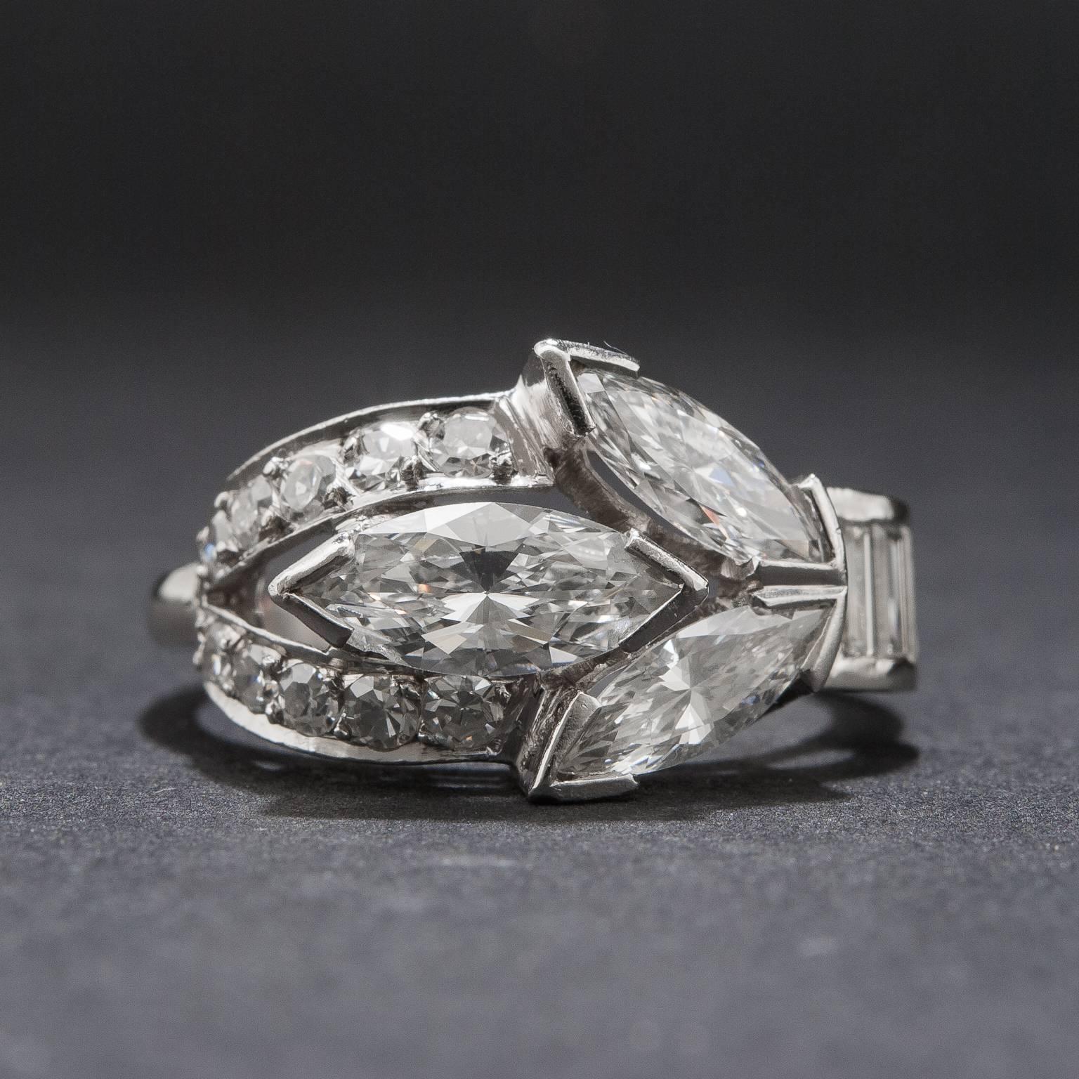 An extraordinary diamond ring crafted circa 1940s. This beautiful piece features a .70 carat center marquise cut diamond as well as two additional marquise cut diamonds for a total of .80 carats. The size 6.5 platinum mounting also includes an