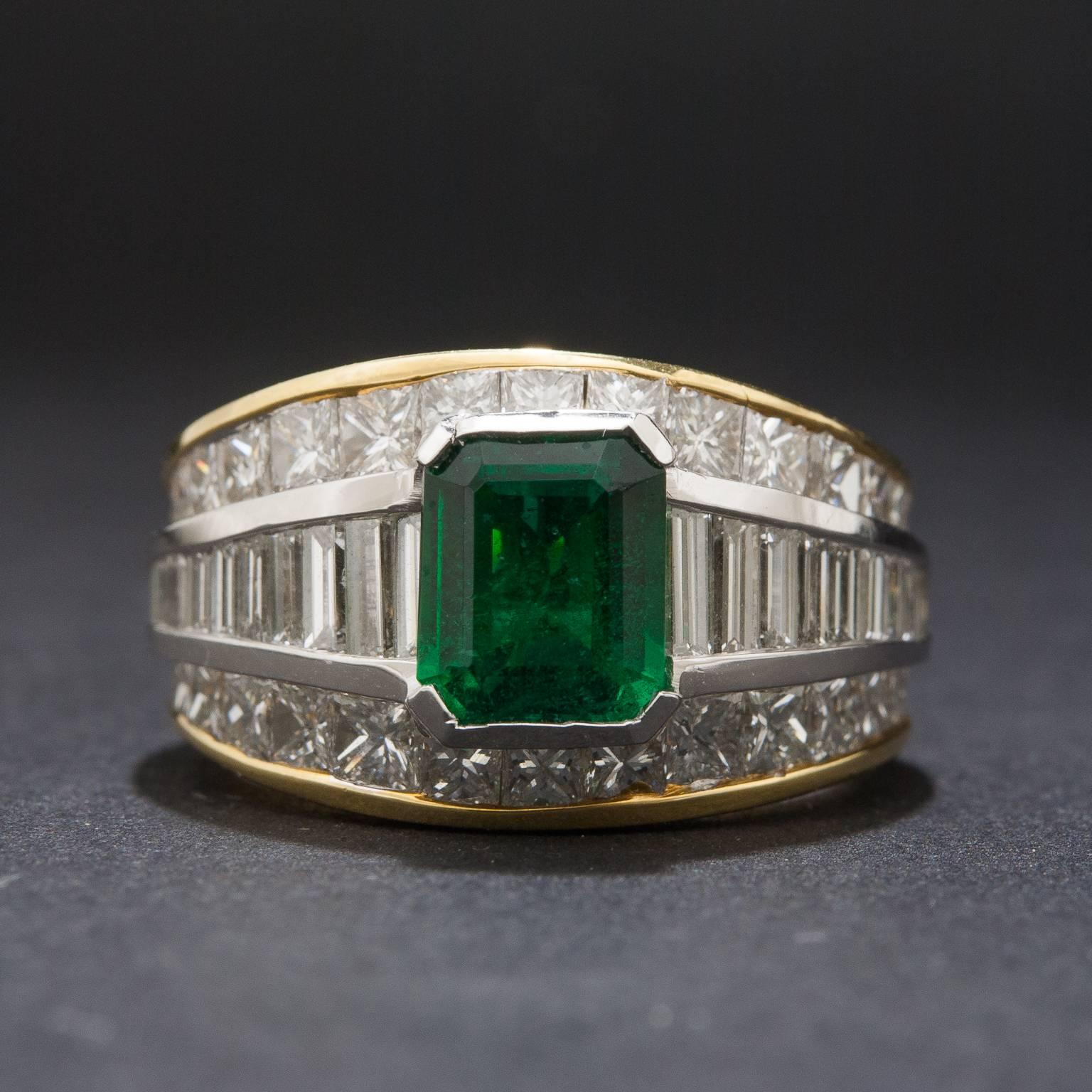 This stunning ring features a gorgeous 1.30 carat emerald and 2.50 total carats of tapered baguette and princess cut diamonds. The mounting is crafted in platinum and 18k yellow gold and it is currently size 6.5.