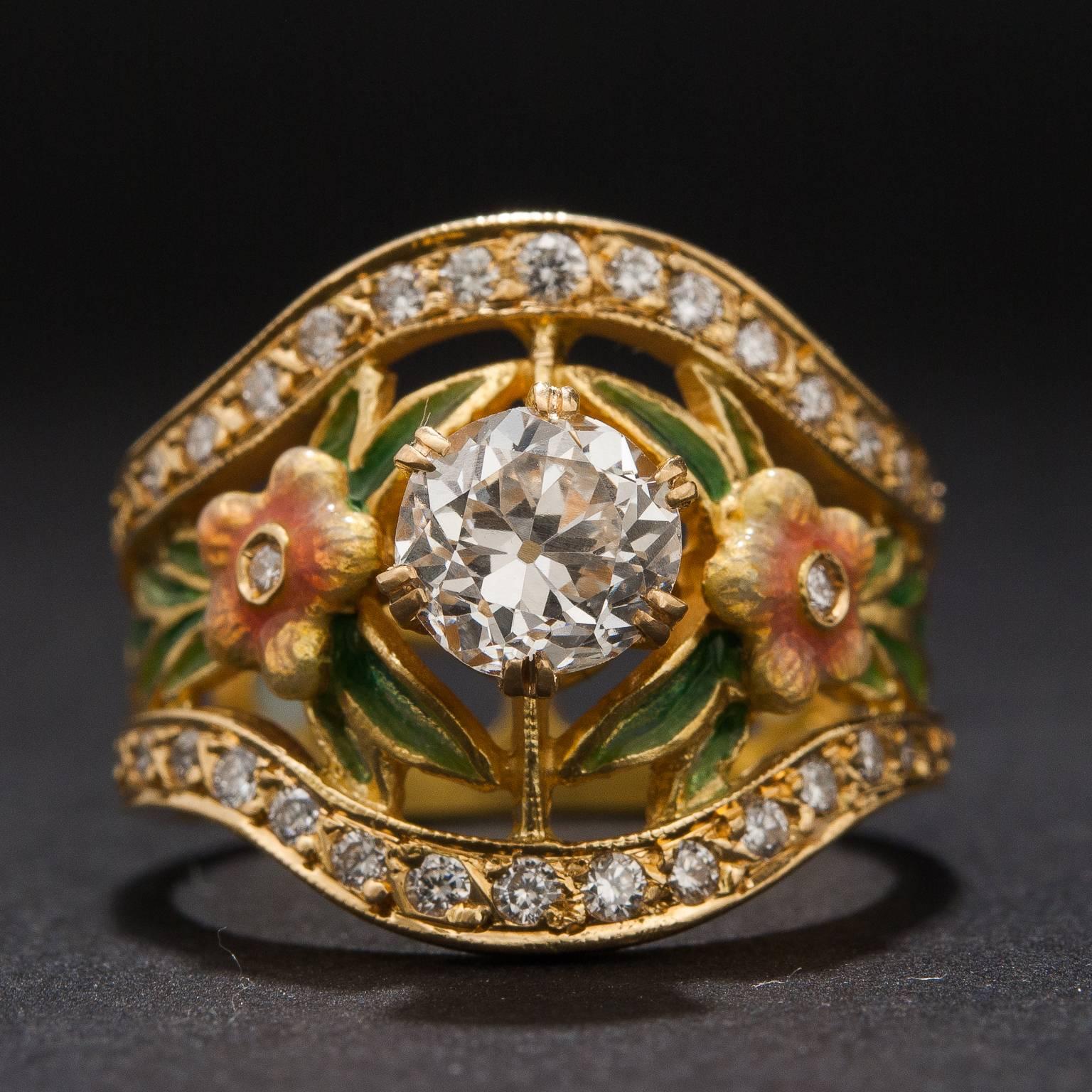 This lovely diamond ring features exquisite enamel work by Masriera. The center diamond is .92 carats and GIA certified I color, VS2 clarity. The piece includes an additional .60 total carats of diamonds and is made in 18k yellow gold. This ring is