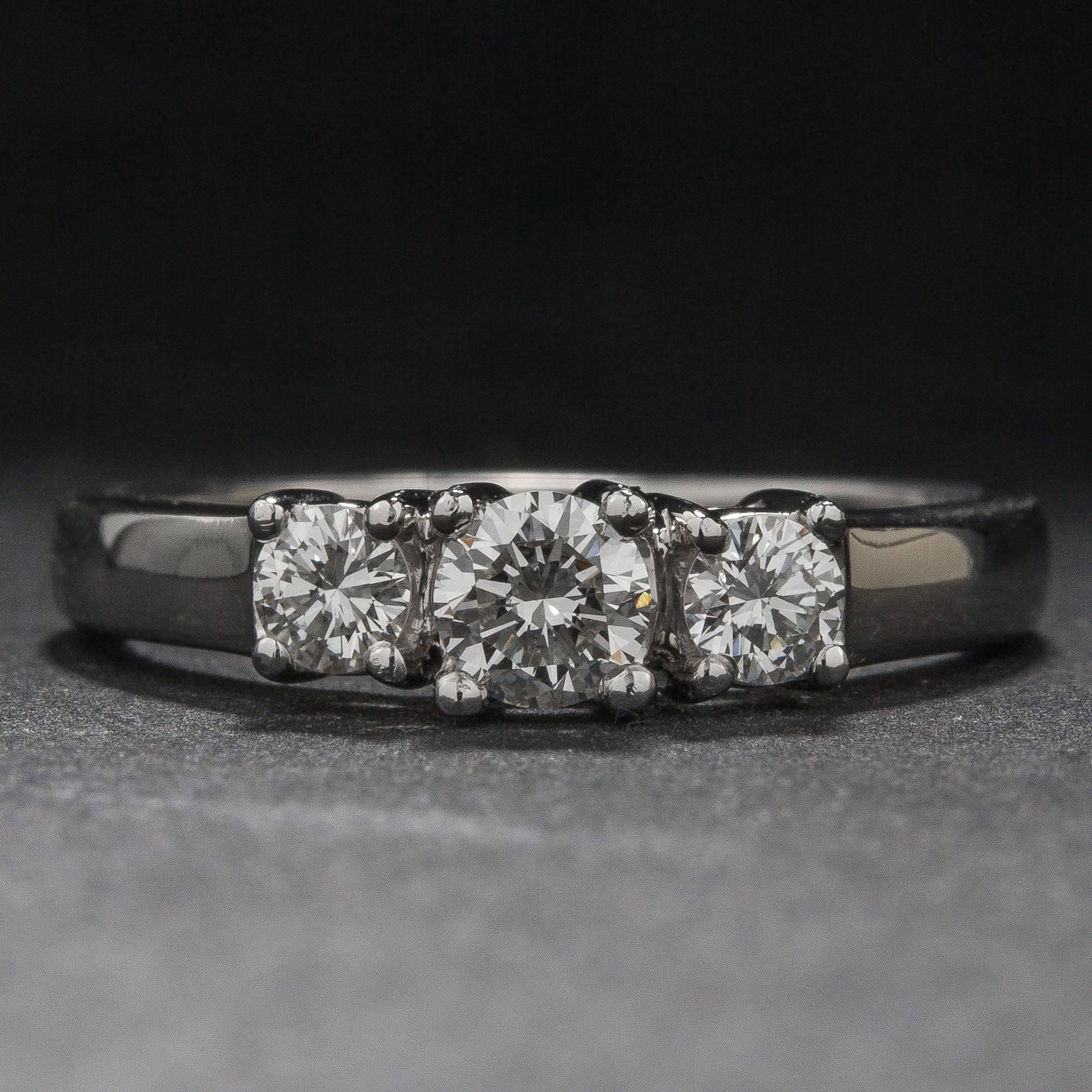 A beautiful three-stone diamond ring with three diamonds weighing a total of .71 carats. This classic mounting is crafted in platinum and the ring is currently size 7.