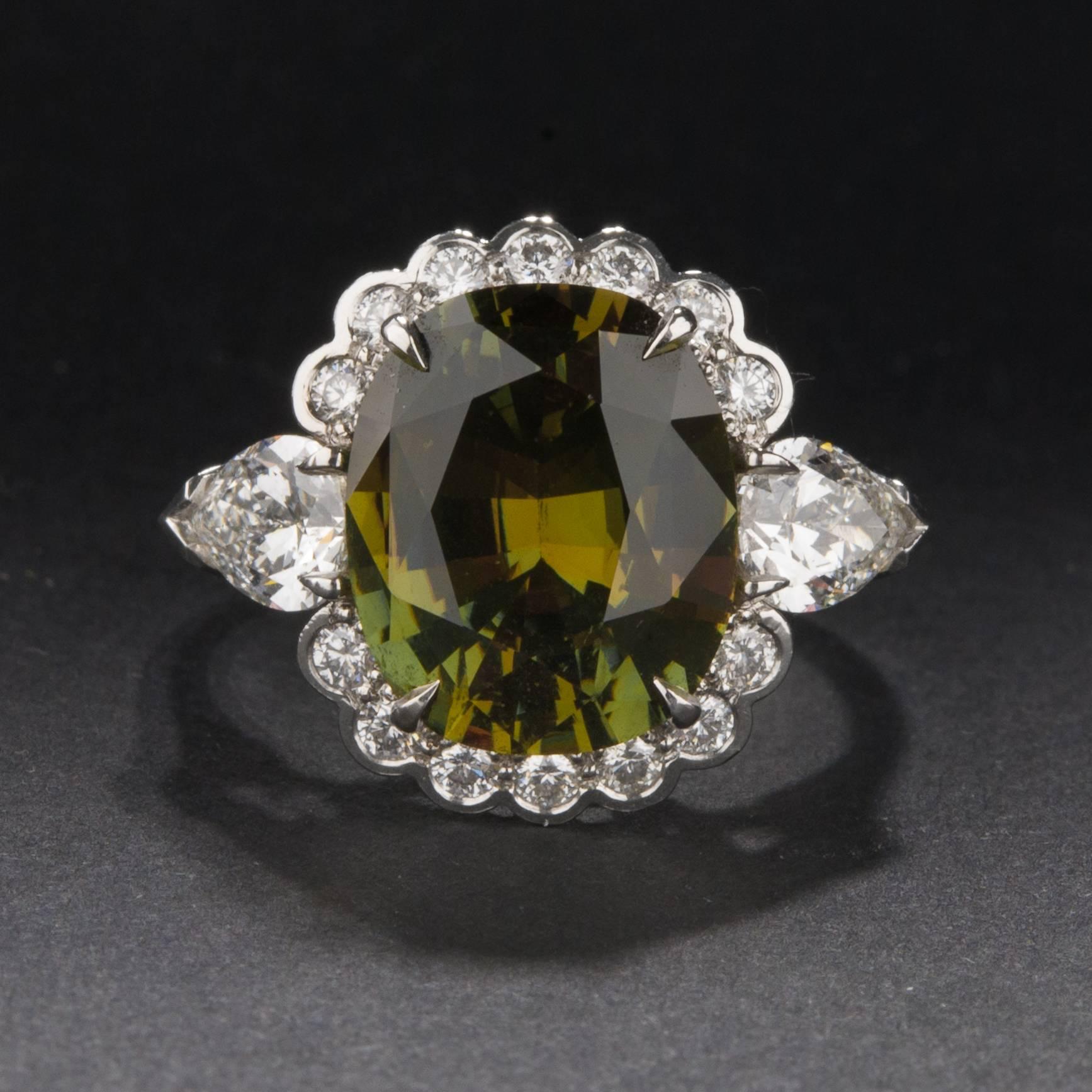 This gorgeous ring features a 5.10 carat GIA certified alexandrite with excellent color change. The extraordinary center stone is flanked by two pear cut diamonds weighing 1.00 carats total, as well as an additional .28 total carats of accent