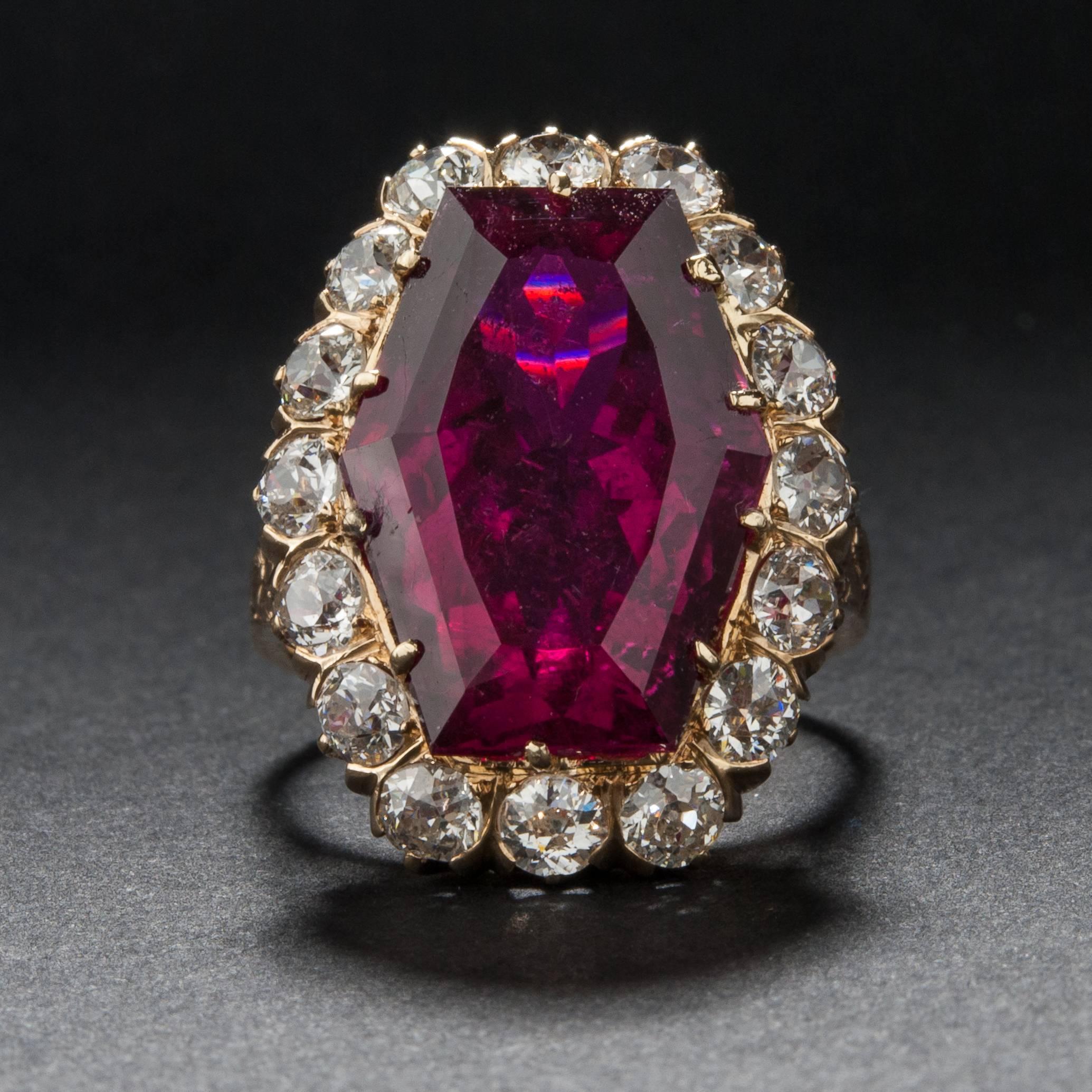 This extraordinary ring features a beautiful 11.00 carat rubelite center stone surrounded by approximately 2.00 carats of accent diamonds. This mounting is crafted in 14k yellow gold and it is currently size 6.