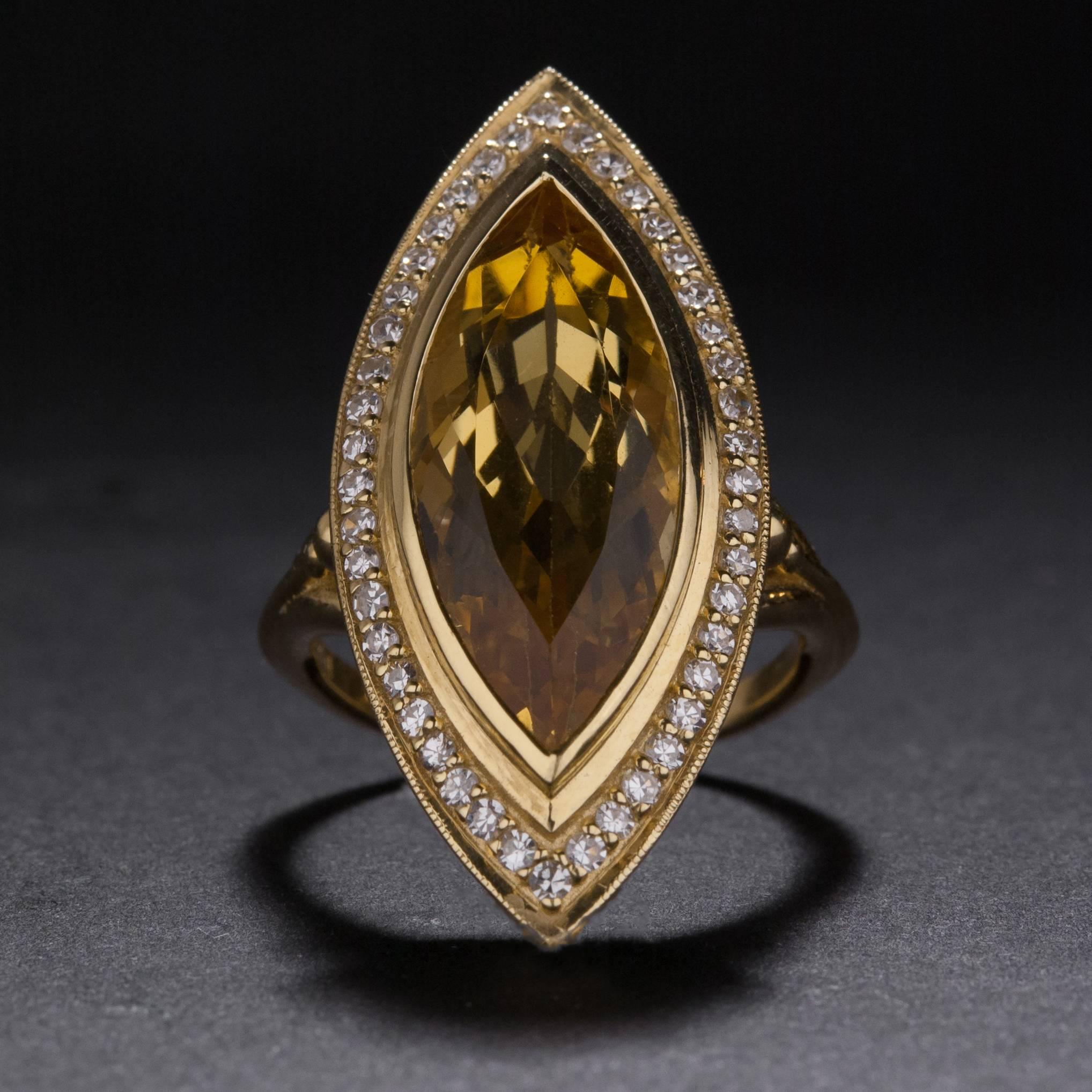 A beautiful 18k yellow gold ring with a 12.00 carat yellow beryl center gemstone and .48 total carats of accent diamonds. This ring is currently size 7.