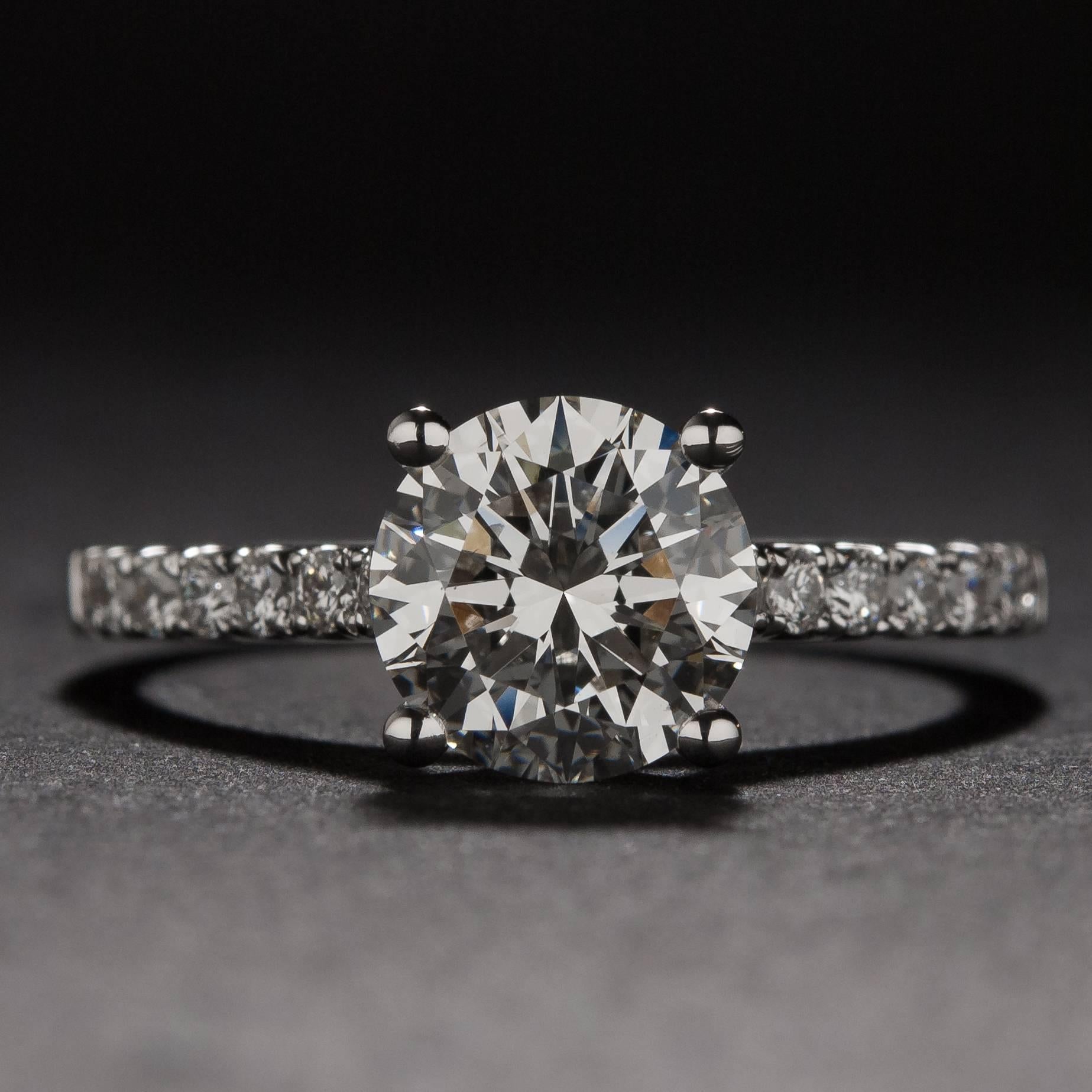 This stunning ring features a 1.51 carat GIA certified center diamond (G color, VS1 clarity) as well as 14 side diamonds weighing a total of .36 carats. The mounting is crafted in 18k white gold and the ring is currently size 6.5.