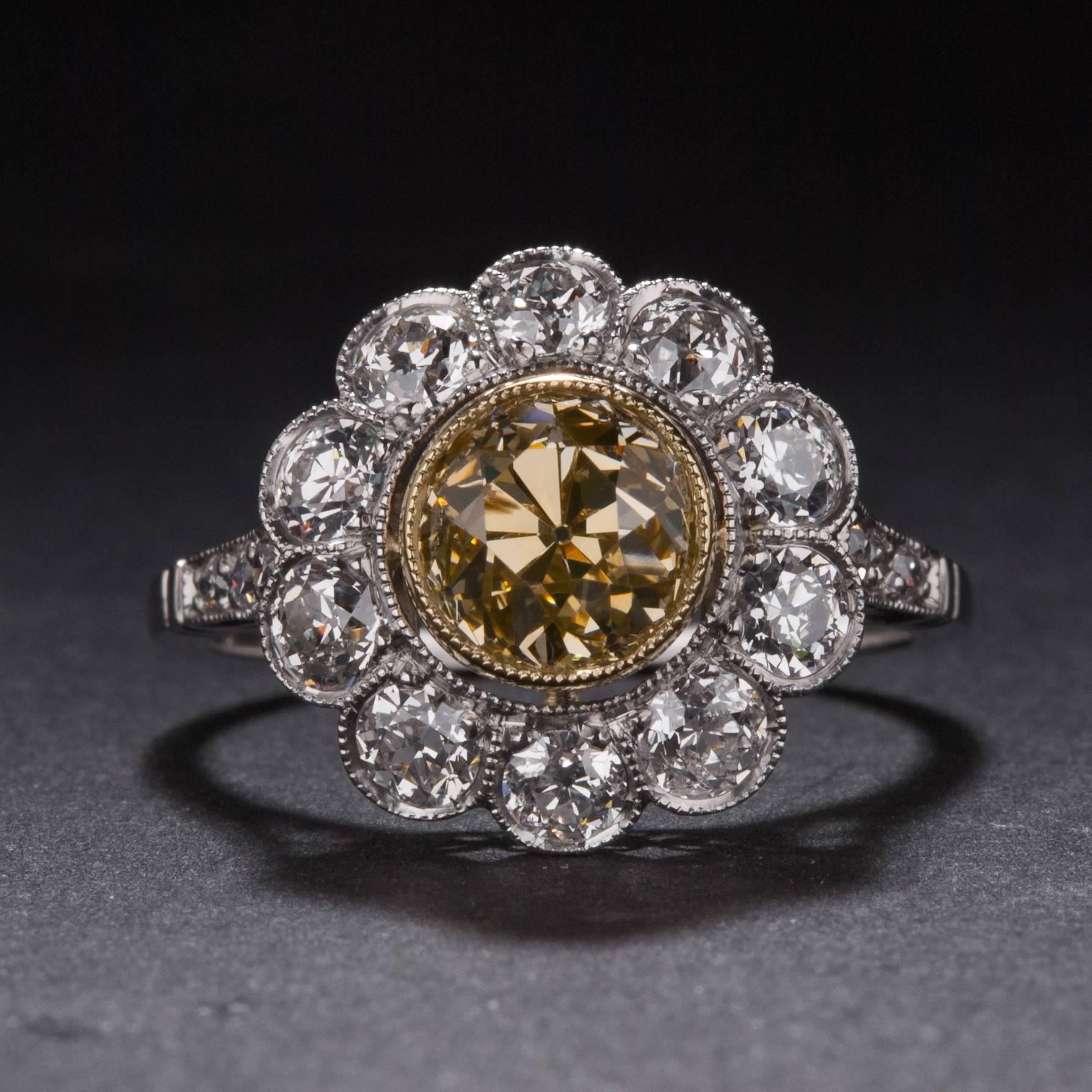 A lovely floral ring hand-crafted circa 1920. This Art Deco era piece features a 1.64 carat Old European Cut diamond (estimated VS clarity) and 16 accent diamond weighing a total of 1.05 carats. The mounting is crafted in platinum and it is