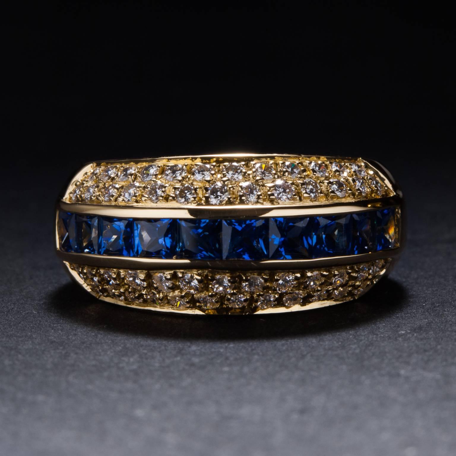 This lovely sapphire and diamond band is made in 18k yellow gold with 1.56 carats of blue sapphires and .48 carats of diamonds. This is a striking and unique gemstone band with vibrant blue channel set sapphires and dazzling white diamond accents.