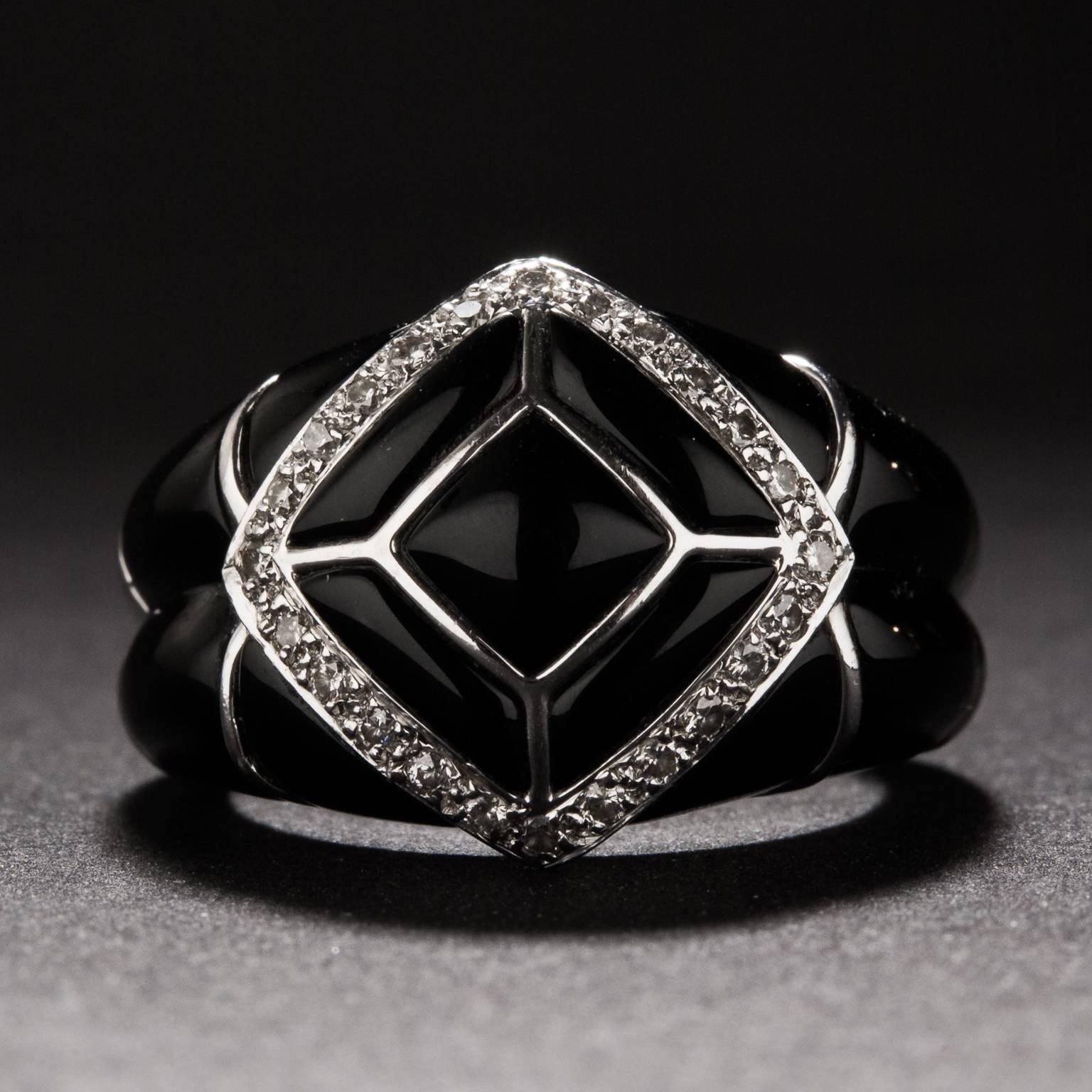 This striking onyx ring was crafted circa 1970. It features .20 total carats of diamonds and it constructed in platinum.