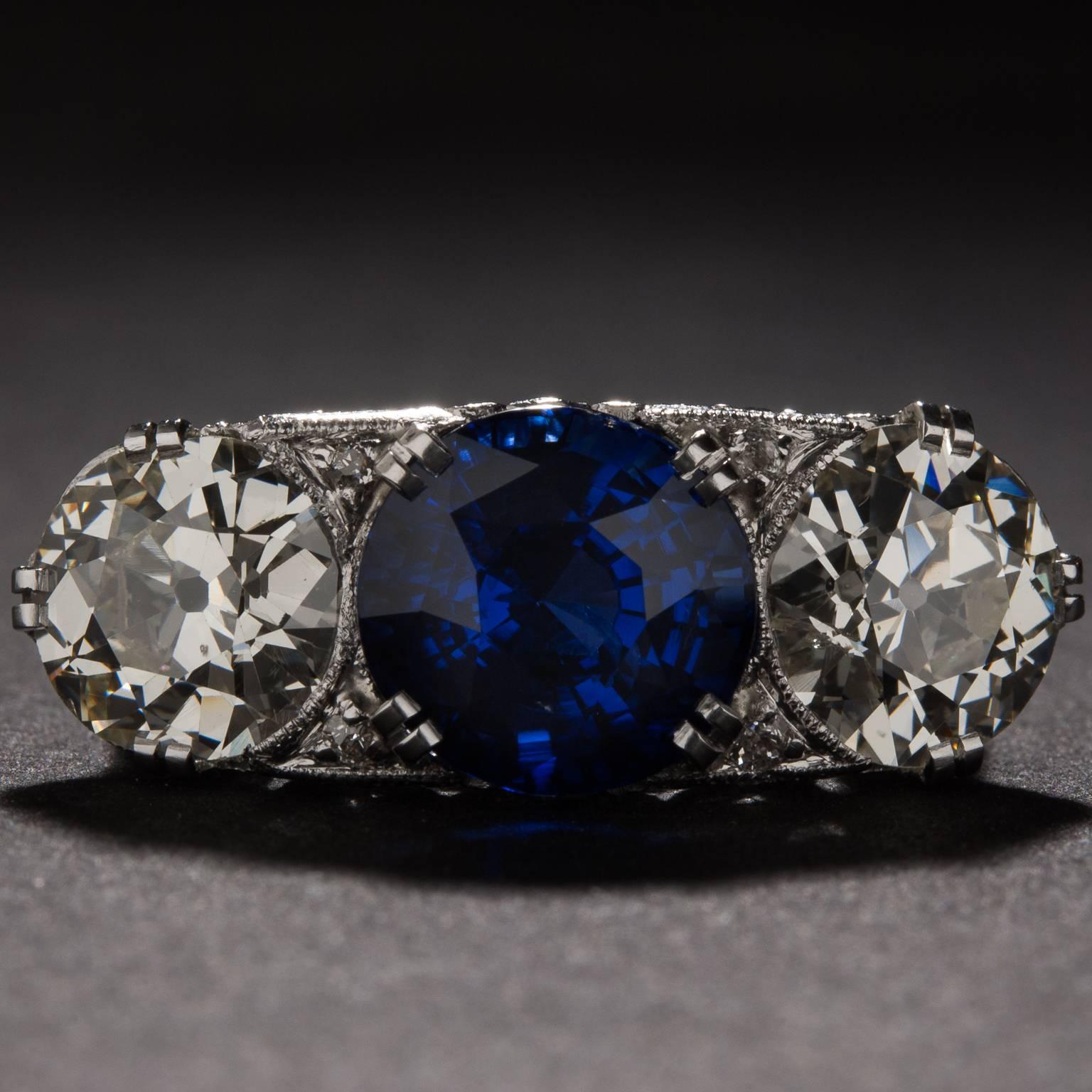 This extraordinary Art Deco era ring features a 4.08 carat center sapphire which is accented by 2 large diamonds weighing 1.63 carats and 1.66 carats respectively. The ring was made in platinum circa 1920 and is currently size 6.