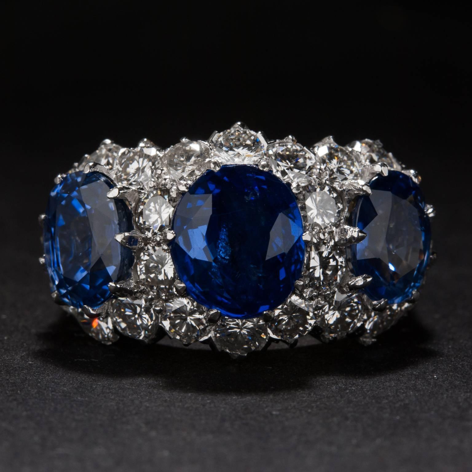 This stunning ring features 3 beautiful sapphires weighing a total of 6.37 carats and 2.74 total carats of accent diamonds. The mounting is crafted in platinum and 18k yellow gold. This ring is currently size 7.5 and may be sized to fit. 
