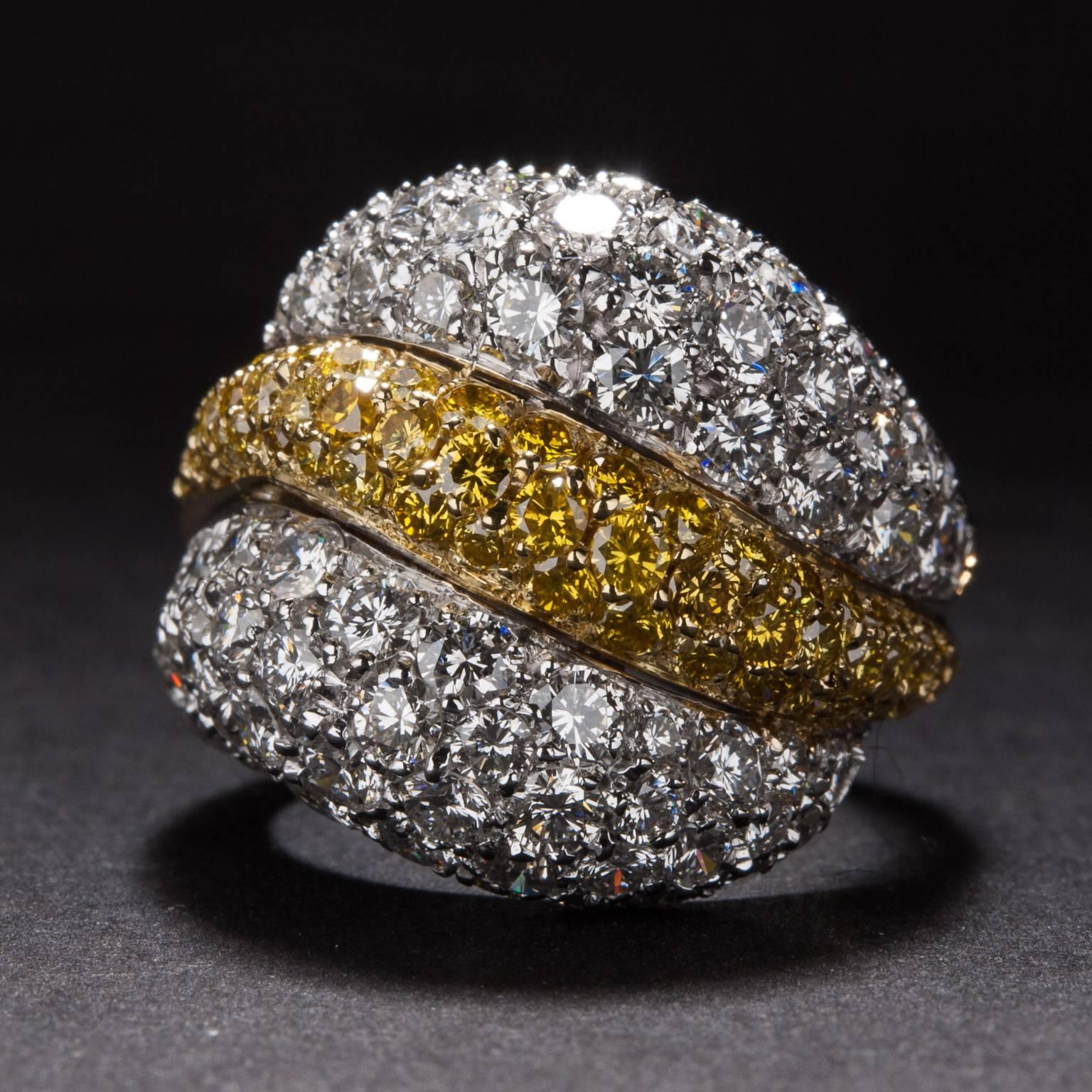 A bold and beautiful ring from Italian designer Luca Carati. This stunning piece features 3.98 total carats of white diamond (E-F color, VS2 clarity) and .98 total carats of yellow diamond. The elegant two-tone mounting is crafted in 18 karat gold.