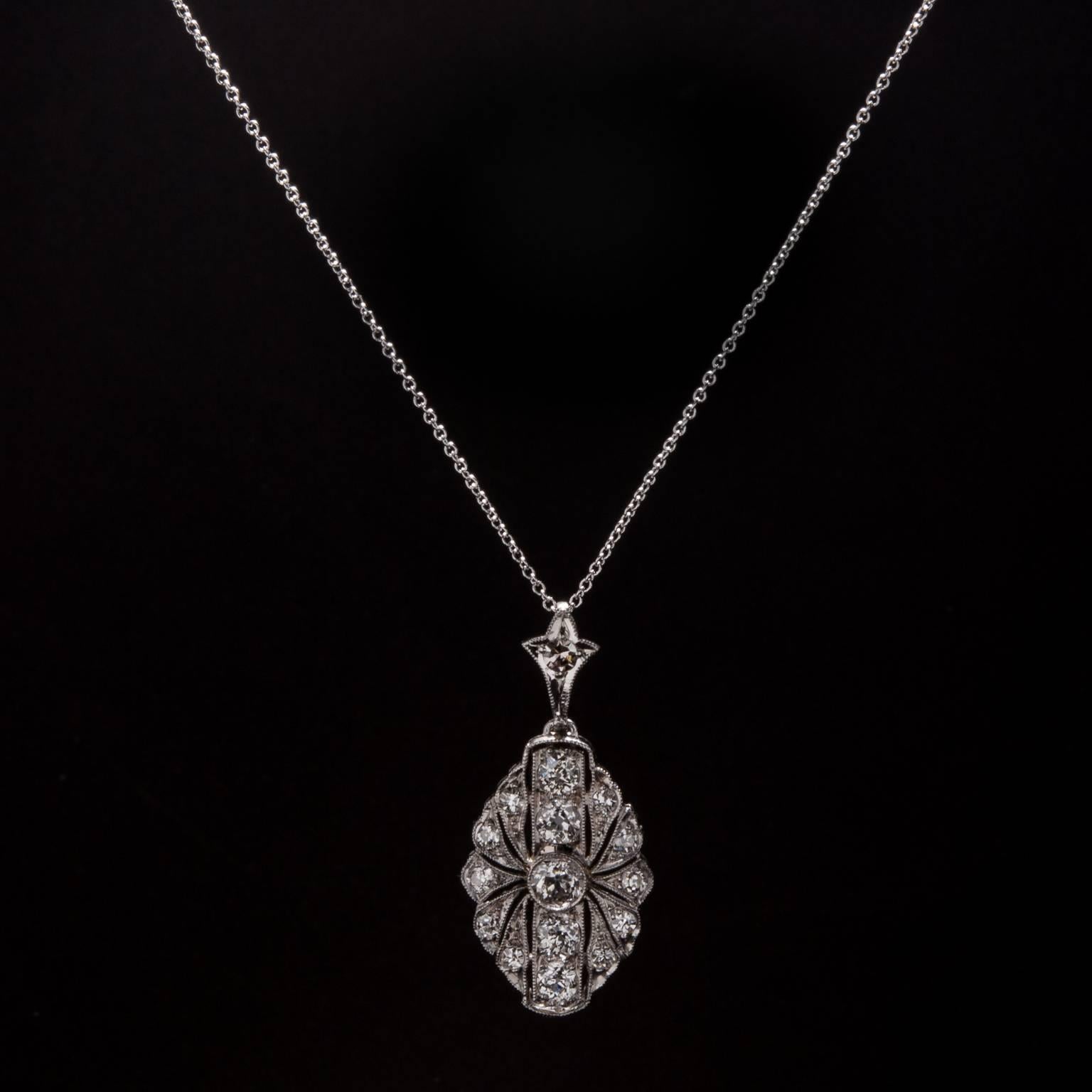 This lovely Art Deco era pendant features a .25 carat old European cut center diamond and .96 total carats of accent diamonds. This piece was crafted in platinum circa 1920 and come on an 18 inch platinum chain.