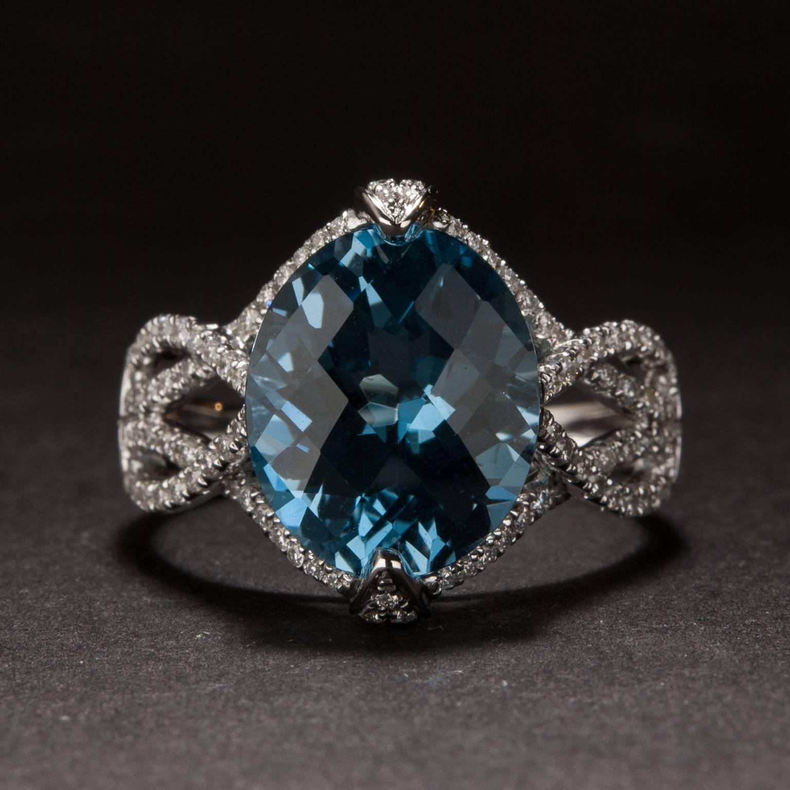 This extraordinary ring features a 5.50 carat blue topaz at it's center and .33 total carats of diamond along its elegantly designed shank. The mounting is crafted in 14k white gold and is size 7.25.