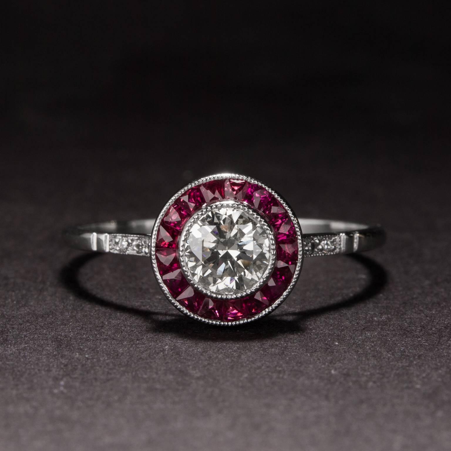 This stunning ring features a .46 carat Old European Cut center diamond with .40 total carats of channel set ruby accents. The mounting is crafted in platinum  and it is currently sized at 7.25.