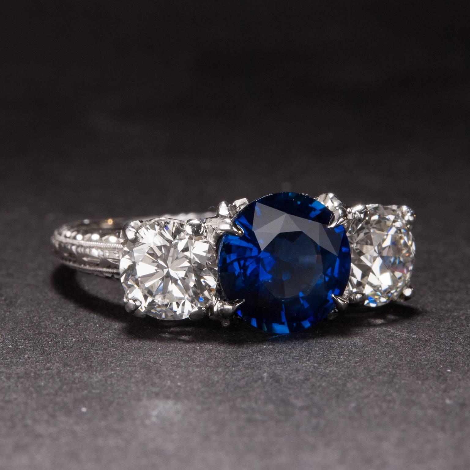 An extraordinary sapphire and diamond ring, crafted circa 1930. The center sapphire weighs 1.76 carats and it is accent by 2 diamonds which weight a combined total of 1.25 carats. The mounting is crafted in platinum and the ring is currently size