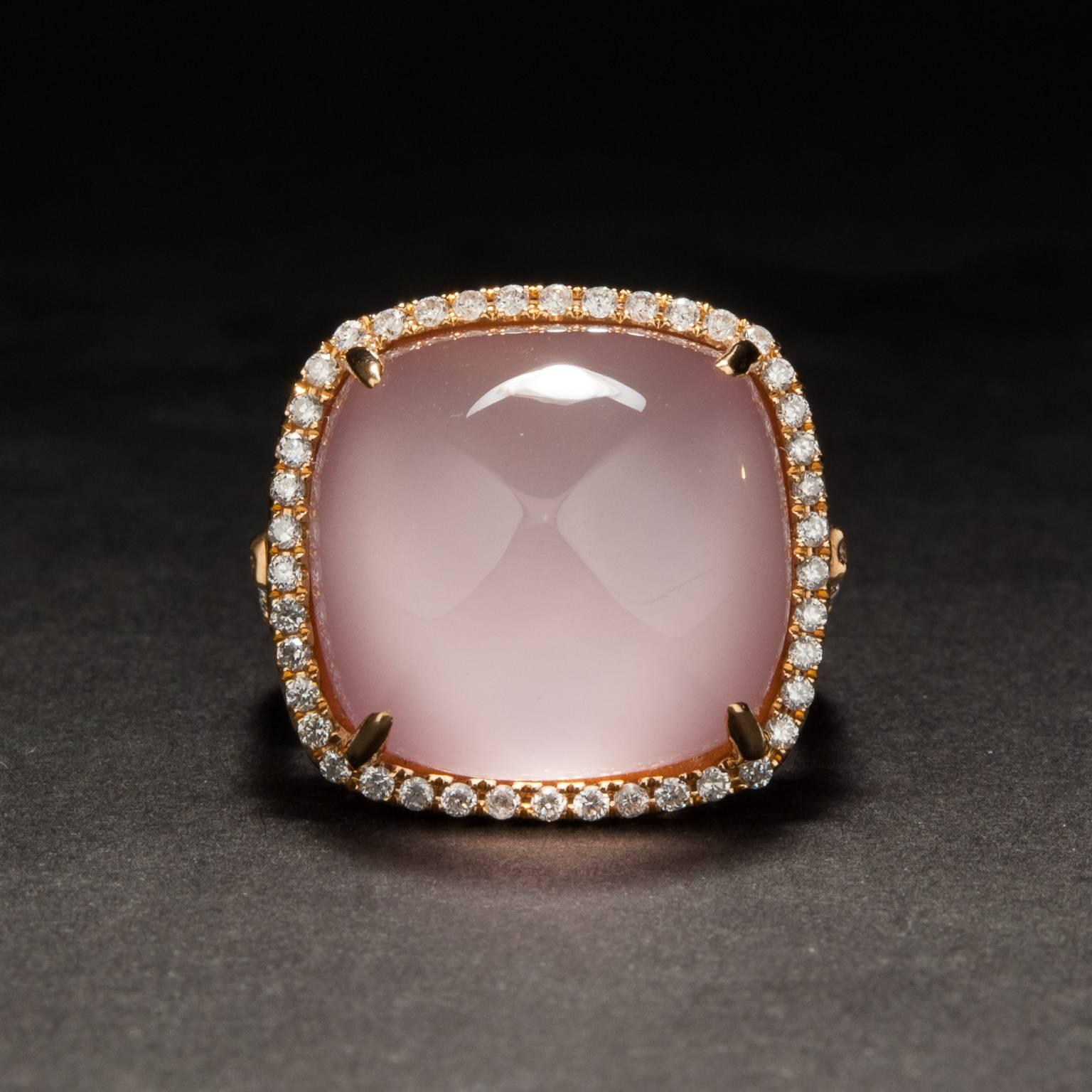 This lovely doublet ring features a large cabochon cut rose quartz over a layer of beautiful pink mother-of-pearl. The ring is made in 18k rose gold and features .56 total carats of bright white accent diamonds.  