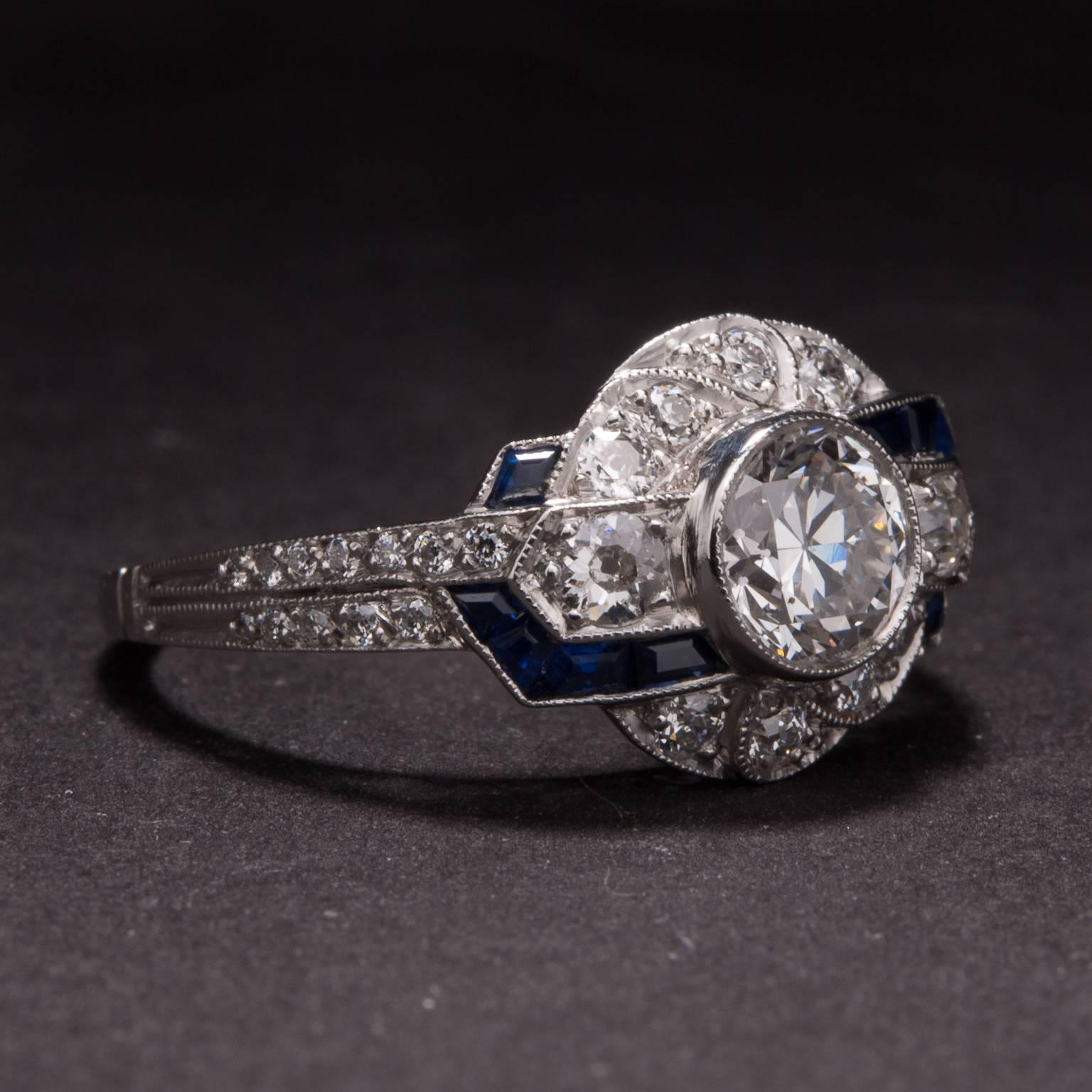 This extraordinary diamond and sapphire ring features a .82 carat center diamond and .25 carat of accent sapphires. The ring is crafted in platinum and the mounting includes an additional .65 carats of accent diamonds. 