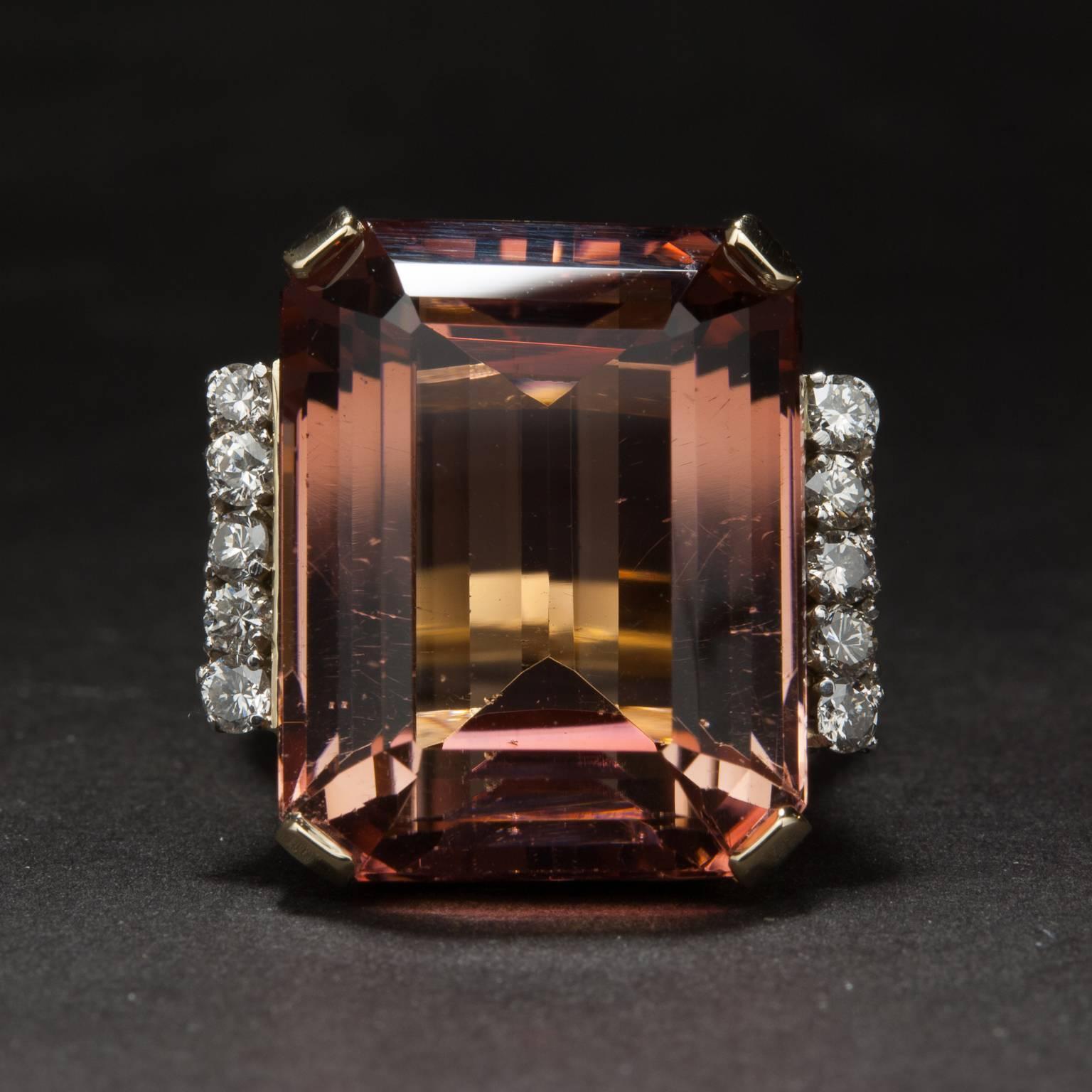 This stunning ring features a 27.90 carat pink tourmaline which is accented by .40 total carats of diamonds. The head of the ring measures 20.4mm wide by 20mm tall by 13mm deep. The ring is made in 18k yellow gold and is currently size 6.5, although