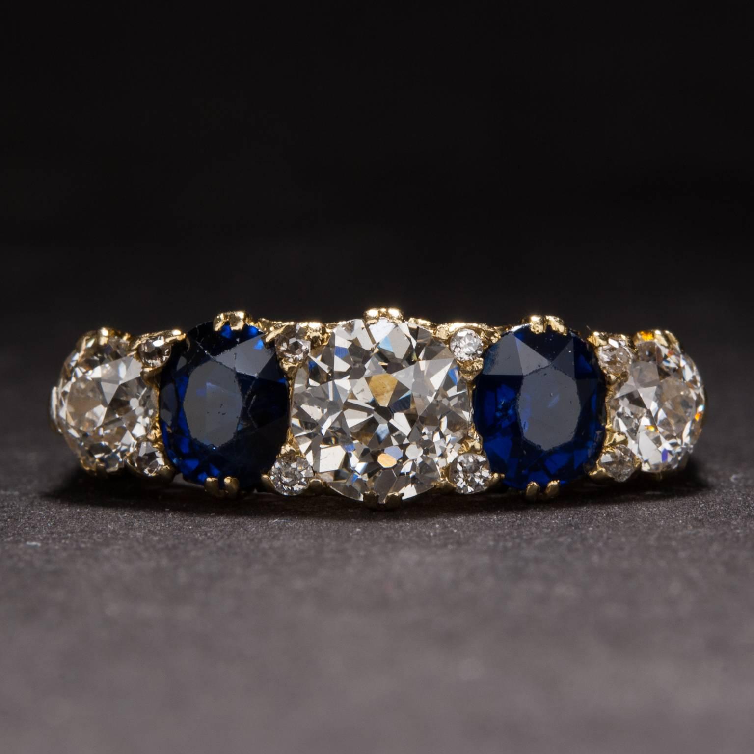 This lovely ring features a .75 carat center diamond, 2 sapphires weighing .40 carats each, and 2 additional side diamonds weighing a combined total of .60 carats. The ring is crafted in 18k yellow gold and is dated circa 1900.