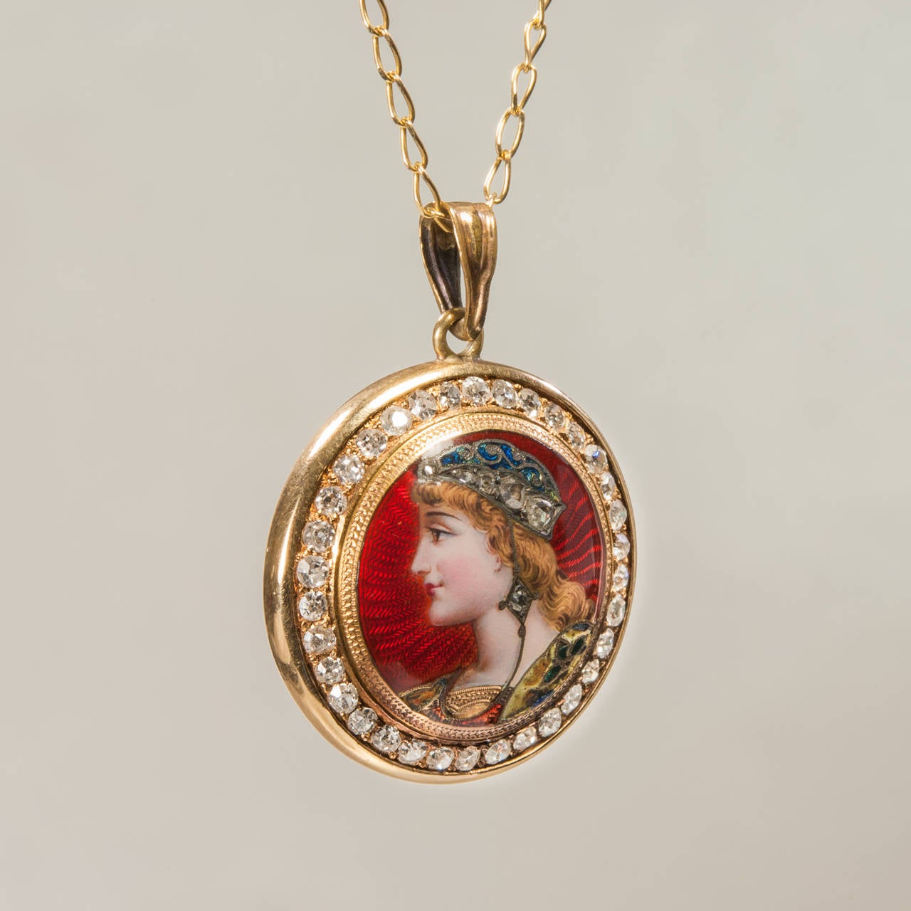 This mint condition Swiss Art Nouveau pendant from the early 1900s is as rare as they come.  A young beauty in profile, resplendent in her rose and single cut diamond encrusted headdress and finely detailed enamel bodice, is the blushing centerpiece