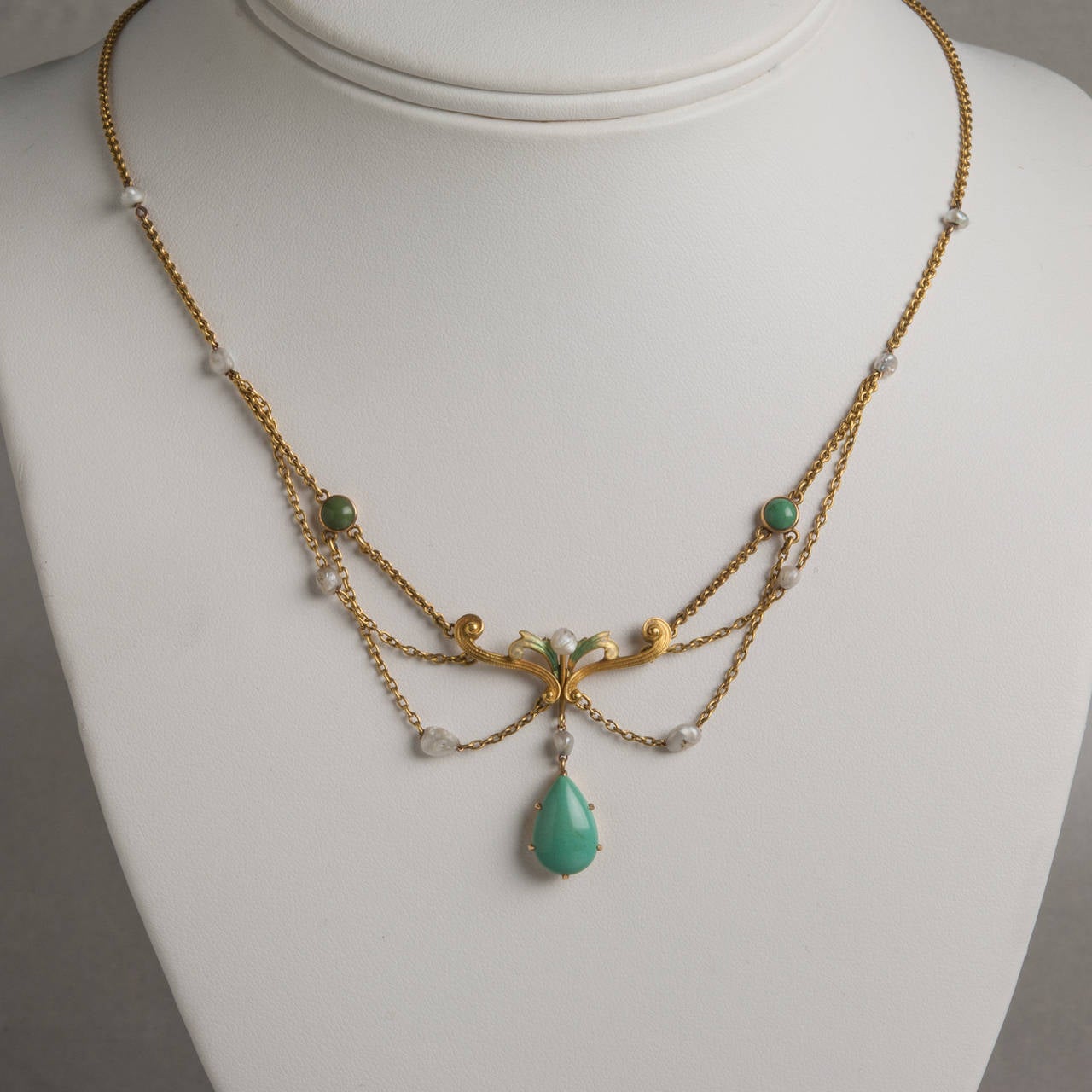 This elegant Art Nouveau necklace features enamel, turquoise and natural pearls on 14k yellow gold. Crafted circa 1915, this stunning piece exemplifies the organic, feminine aesthetic of Art Nouveau design. The necklace measures 16.5 inches.