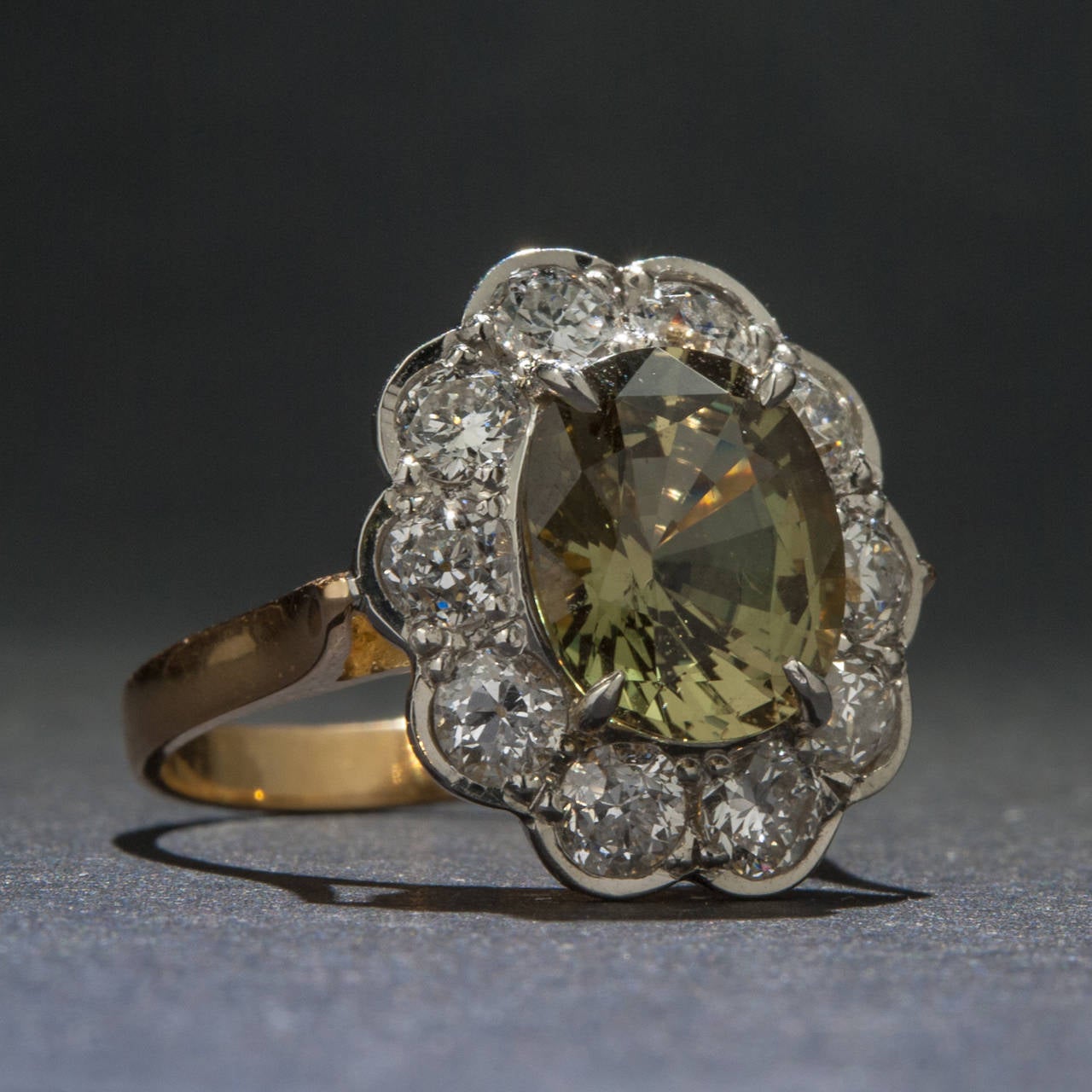 A striking 3.23 carat Alexandrite, Platinum and 18k Yellow Gold Ring. The center stone is GIA/AJI Certified and surrounded by 1.40 total carats of Diamonds with SI1-SI2 clarity, H-I color, and Good cut. The ring is currently sized at 6 1/2.