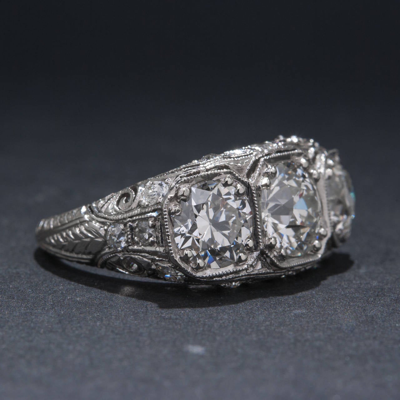 An exceptional Art Deco diamond ring featuring a 1.46 carat center diamond and 2 side diamonds weighing 1.99 carats in total. The diamonds are of  