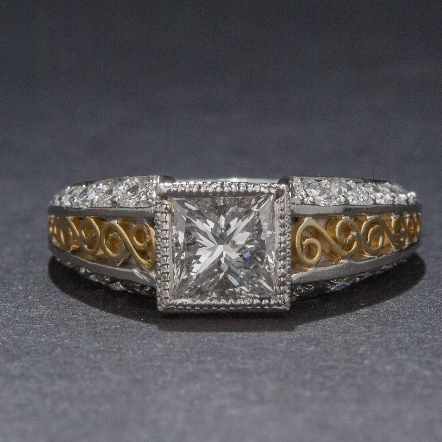 A beautiful .91 carat princess cut diamond dazzles at the center of this extraordinary vintage style ring. The platinum and 18k yellow gold mounting features an additional 28 diamonds for a total weight of .83 total carats. The shank is decorated