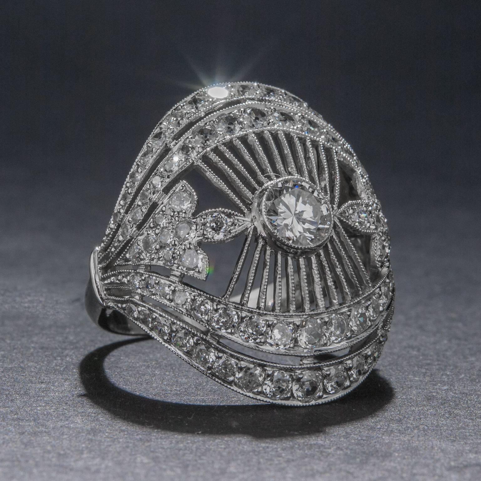 This stunning newly made diamond plaque ring has been crafted in the Art Deco style with extraordinary filigree work and milgrain detailing. The center diamond weighs .50 carats (I color, SI2 clarity) and the accent diamonds weigh a combined total