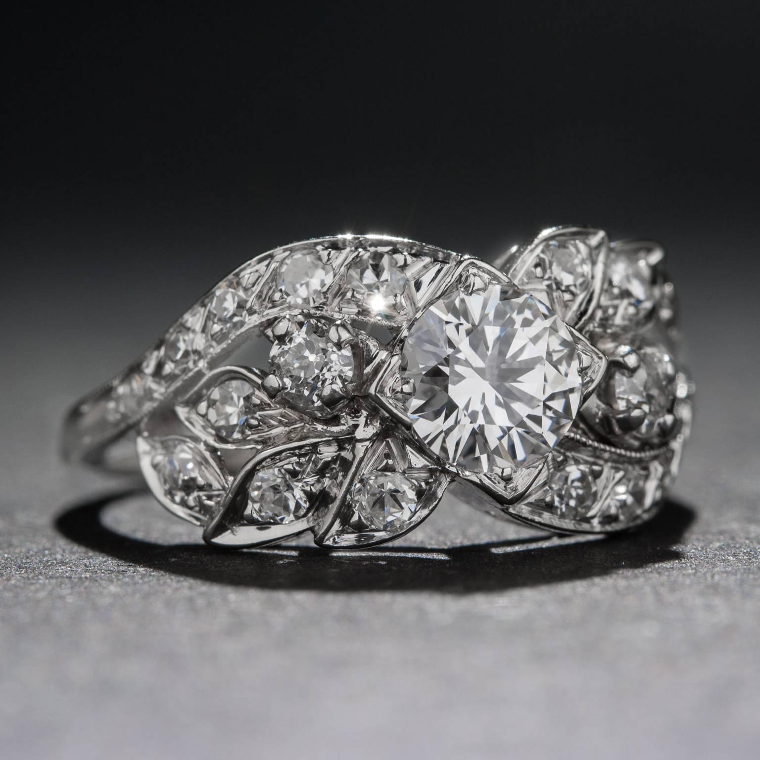 An extraordinarily beautiful diamond ring hand-crafted in the Art Deco design era. This piece features a .50 carat center diamond (G-H color, VS clarity) as well as 20 smaller accent diamonds weighing a total of .50 carats (G-I color, VS=SI