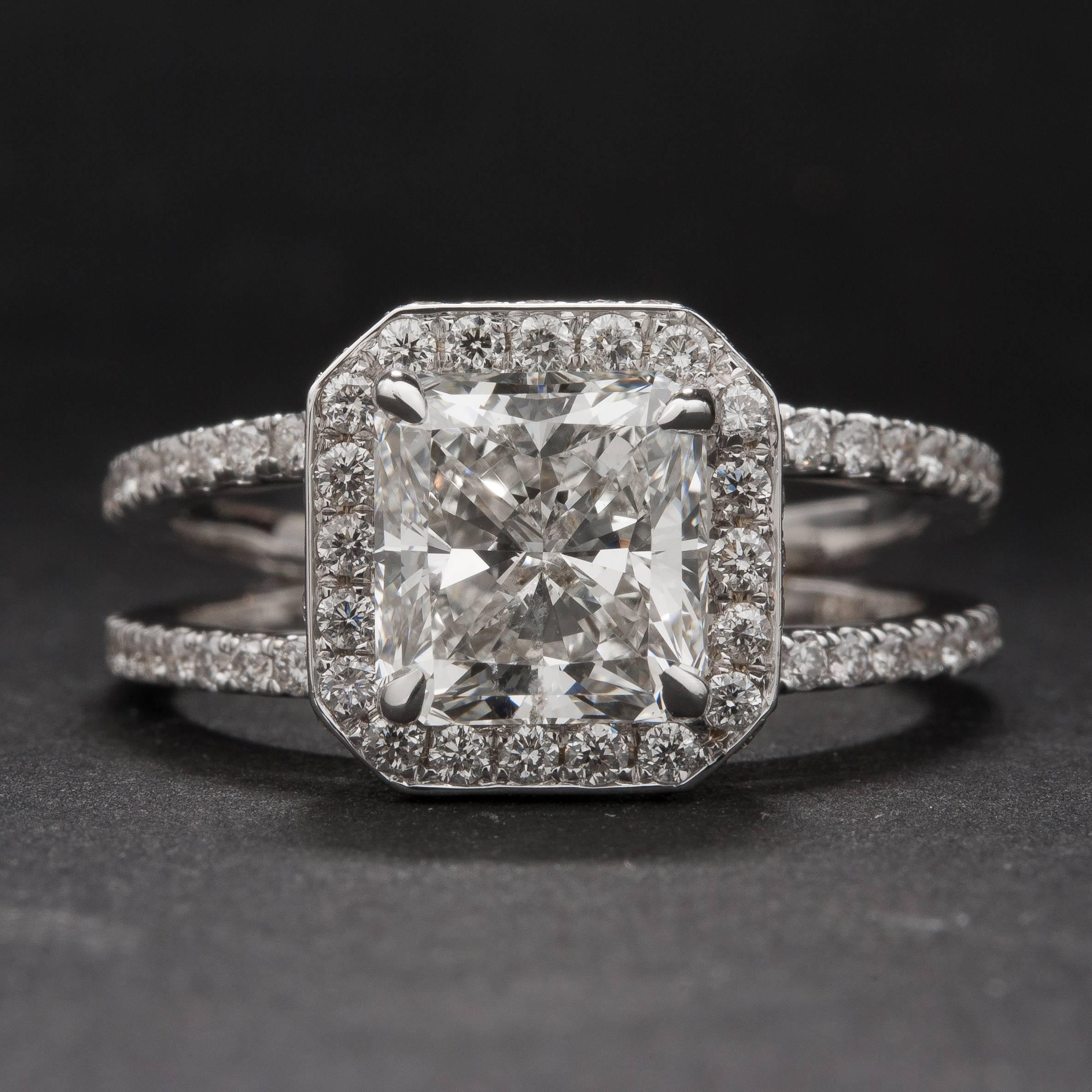A stunning 2.05 carat (est. F color, VS2 clarity) radiant cut diamond ring with an 18k white gold split-shank mounting. The center stone is accented by .90 total carats of side diamonds  and the ring is currently size 6.75.
