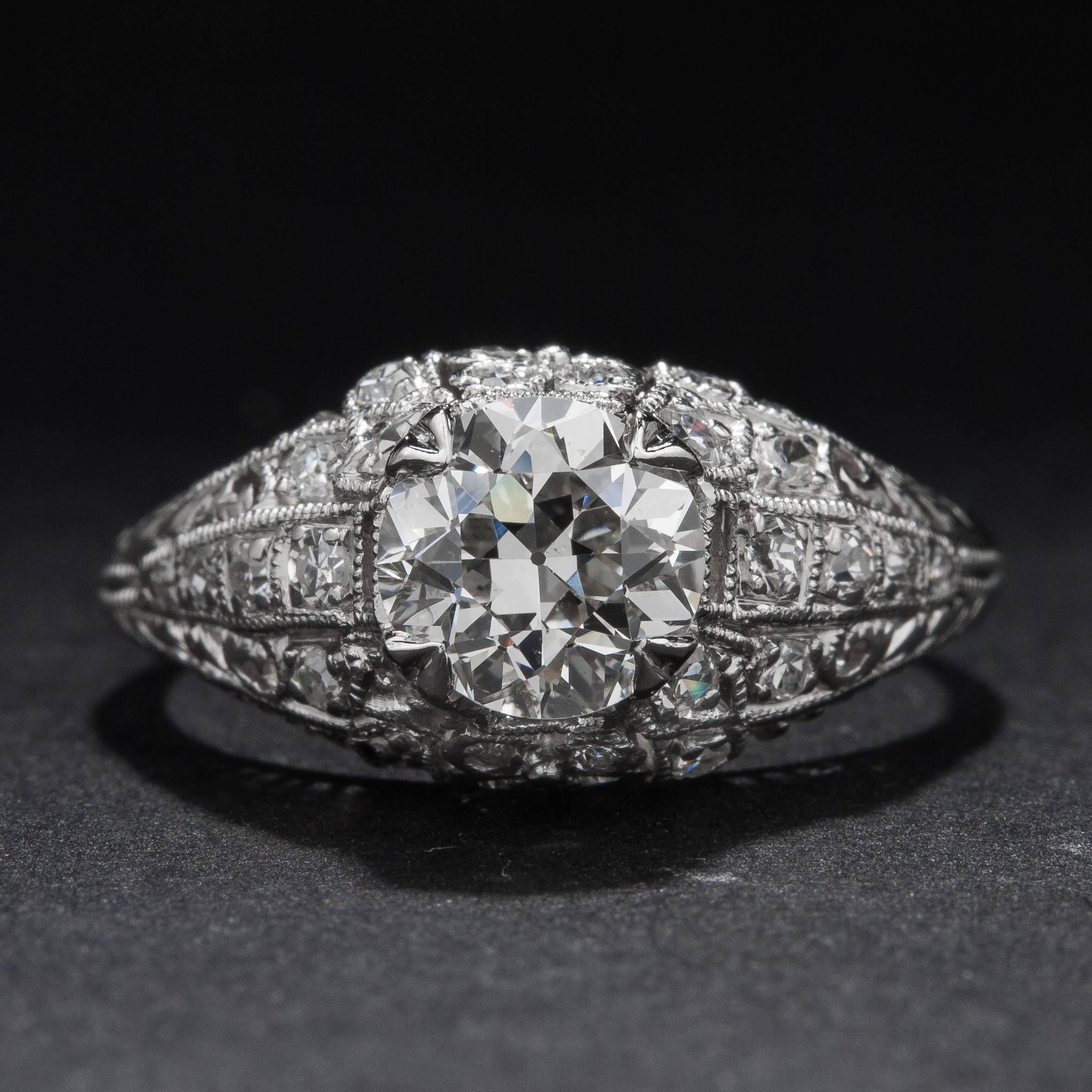 This stunning Art Deco era ring features a 1.02 carat center diamond (H color, VS2 clarity) and .28 total carats worth of accent diamonds. This beautiful mounting is crafted in platinum and the ring is currently size 6.5.